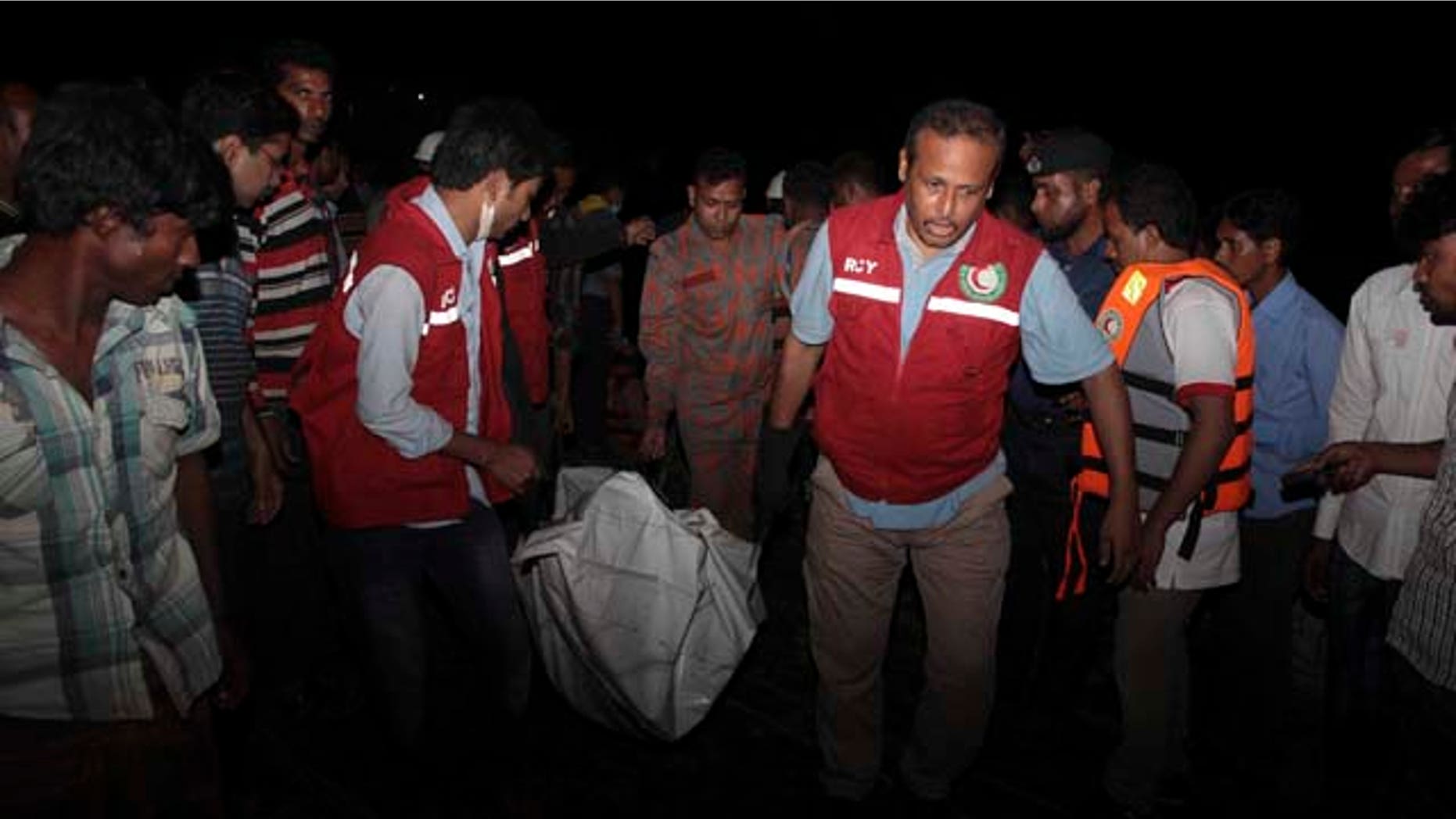 Feb. 22, 2014: Bangladeshi rescue workers carry the dead body of one of the victims after a river ferry carrying unto 140 passengers capsized Sunday after being hit by a cargo vessel,in Manikganj district, about 25 miles northwest of Dhaka. (AP Photo/ A.M. Ahad)