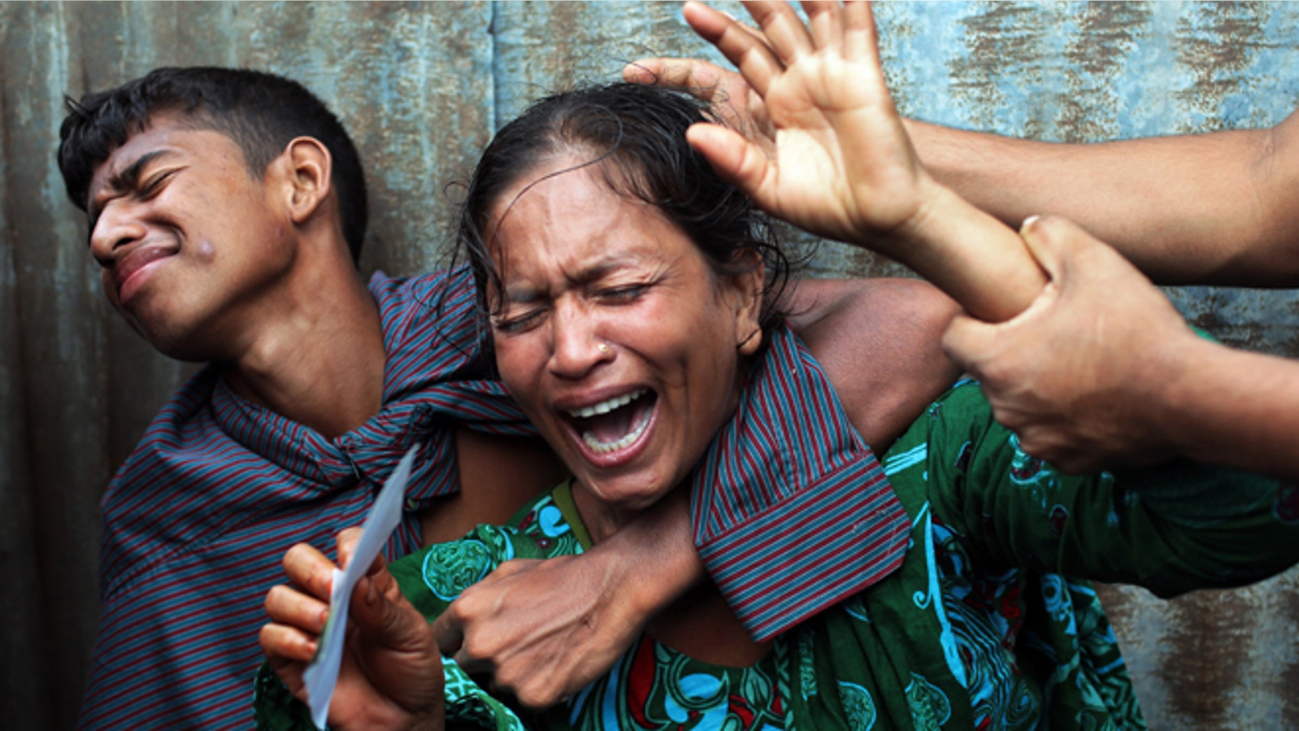 Aug. 4, 2014: Bangladeshi woman Munni, whose daughters are missing, cries as rescuers search the River Padma after a passenger ferry capsized in Munshiganj district, Bangladesh. (AP)
