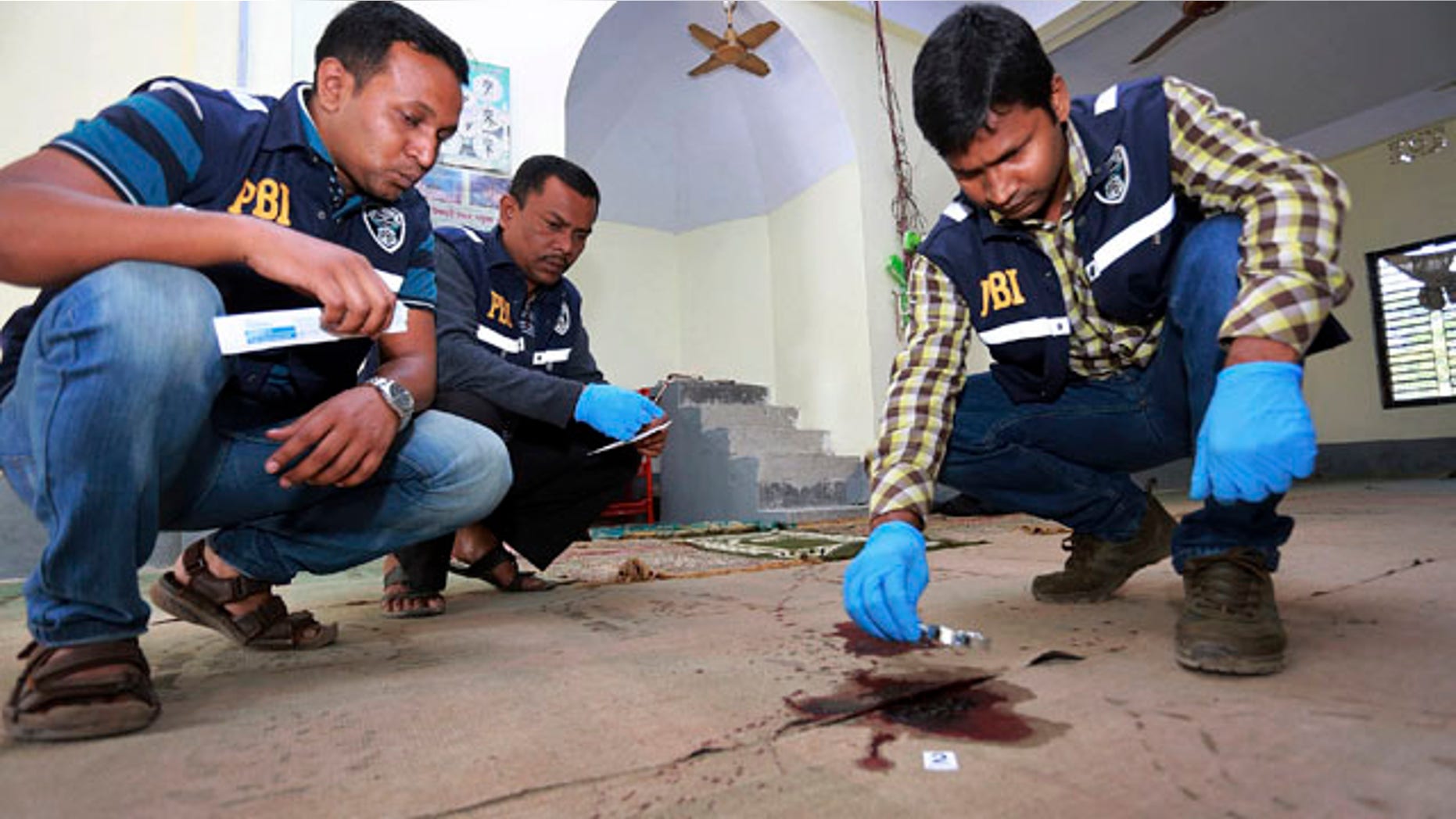 Nov. 27, 2015: Investigators inspect a mosque that was attacked by unidentified gunmen during evening prayers on Thursday in northern Bangladesh's Bogra district. (AP Photo)