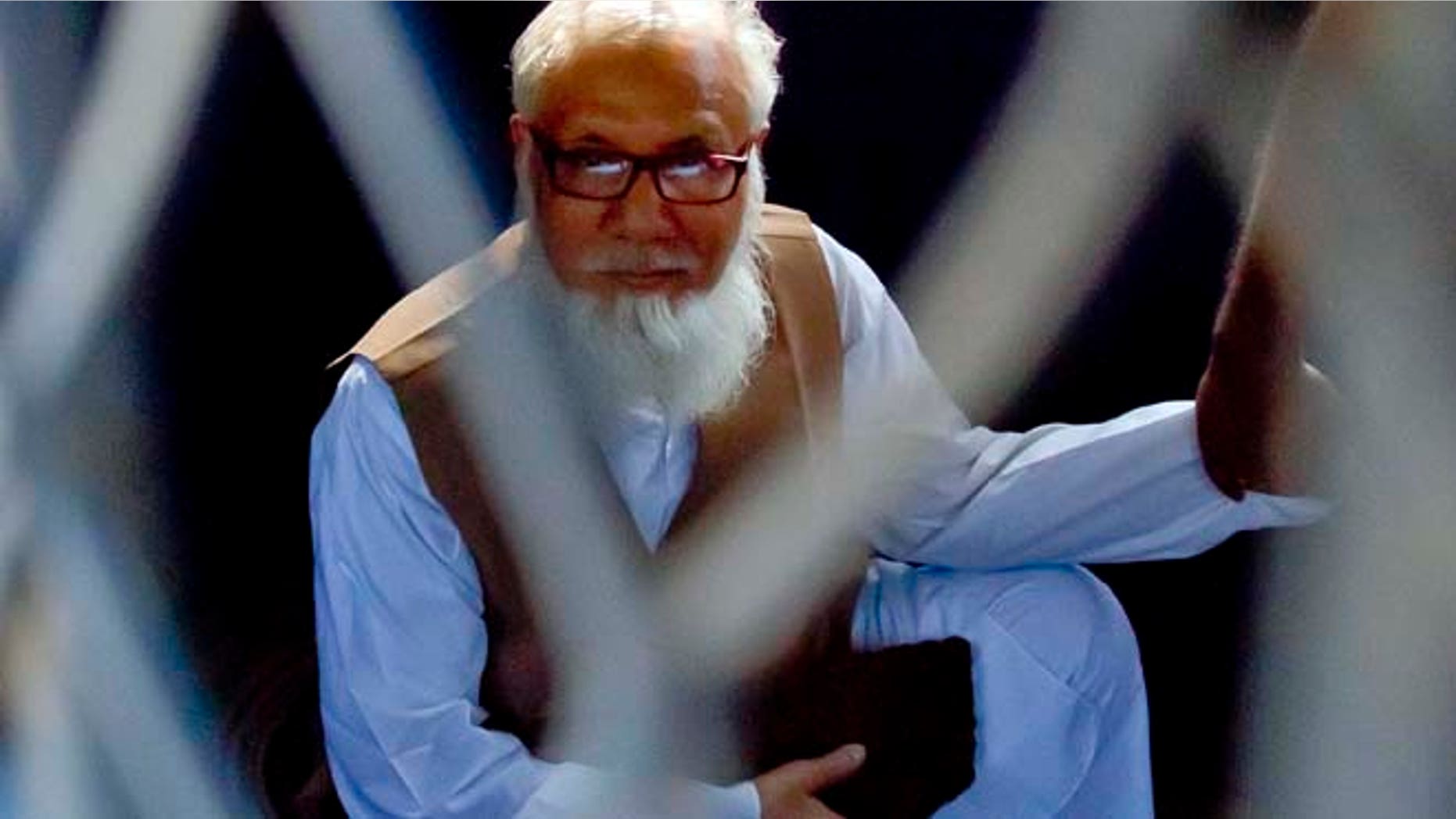 Oct. 29, 2014: Jamaat-e-Islami chief Motiur Rahman Nizami sits inside a police van after he was sentenced to death for his role in the deaths of thousands of people during the nation's independence war against Pakistan in 1971, in Dhaka, Bangladesh. (AP)