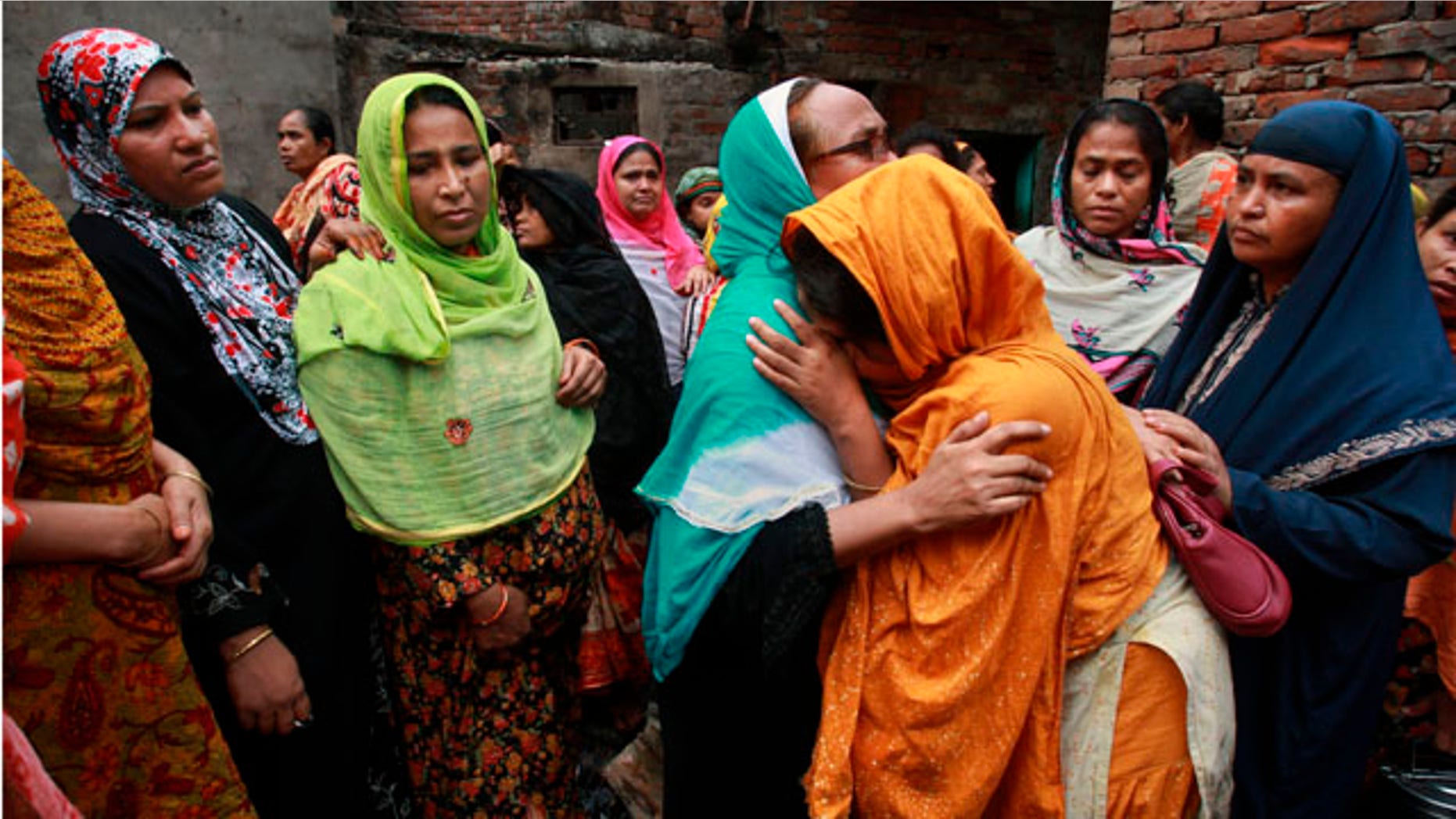 June 4: Relatives mourn the death of a victim of a fire in Dhaka, Bangladesh. The devastating fire raced through several apartment complexes in the Bangladeshi capital Thursday, killing and injuring scores of people. (AP)