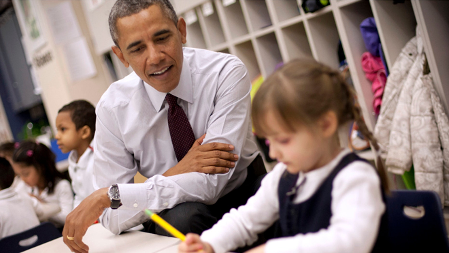President Barack Obama sits with Emily Hare as she completes her spelling lessons during his visit to a preschool classroom at Powell Elementary School in the Petworth neighborhood of Washington, Tuesday, March 4, 2014. Obama visited the school to talk about his 2015 budget proposal, which was released today. Powell elementary has seen rapid growth in recent years and serves a predominantly Hispanic student body. Washington DC Mayor Vincent Gray, who greeted Obama at the school, recently directed $20 million to Powell for a planned modernization and addition. (AP Photo/Pablo Martinez Monsivais)