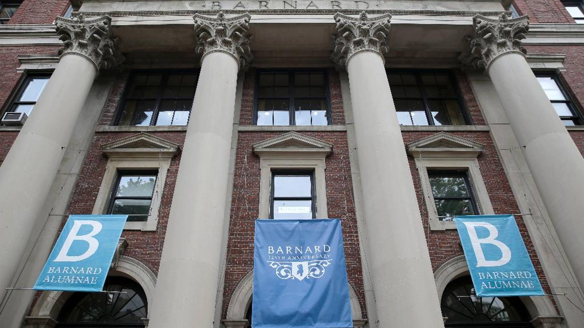 FILE - In this May 28, 2015 file photo, banners hang from a building at Barnard College in New York. Barnard College has decided to admit transgender women, becoming the latest women’s college to issue a new policy acknowledging the fluidity and complexity of gender. (AP Photo/Seth Wenig, File)