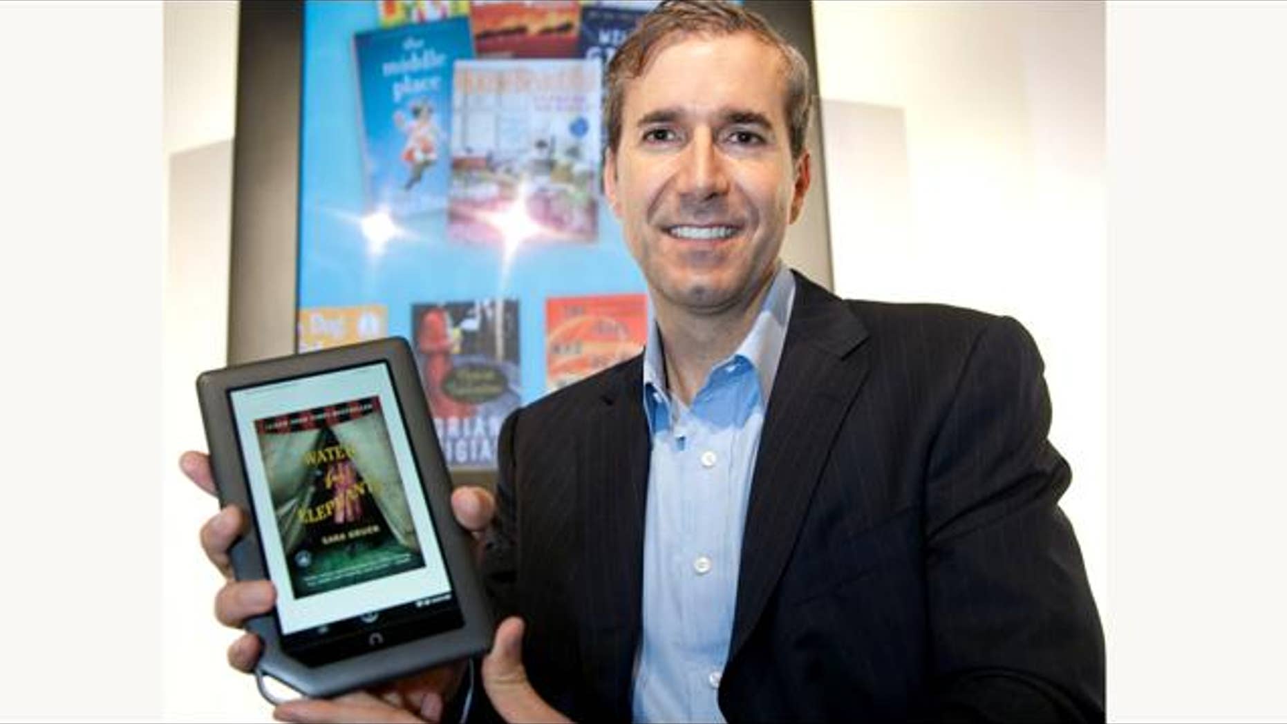 William Lynch, Chief Executive Officer of Barnes & Noble, holds the new NOOKcolor, the first full-color touch reader's tablet, prior to its introduction in New York on Tuesday, October 26, 2010. Designed to read many types of content, NOOKcolor has a 7-inch display that showcases books, a large selection of magazines and newspapers and children's picture books in rich color.