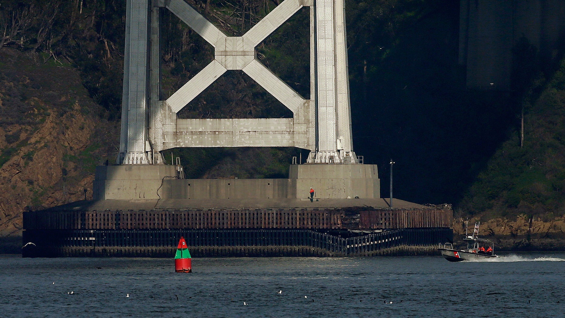Jan. 7, 2013: A worker inspects damage to the bottom of a tower on the San Francisco-Oakland Bay Bridge in San Francisco.