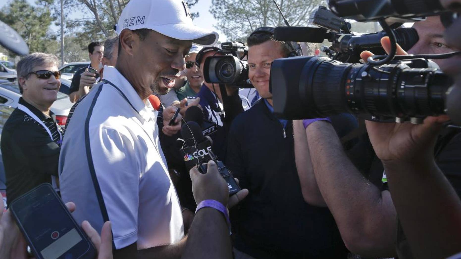 FILE - In this Feb. 5, 2015, file photo, Tiger Woods speaks to reporters after withdrawing during the first round of the Farmers Insurance Open golf tournament in San Diego. Woods won't be at Bay Hill next week for the Arnold Palmer Invitational. He still isn't ruling out the Masters. Woods said on his website Friday, March 13, 2015, that he will not play at the tournament he has won eight times. (AP Photo/Gregory Bull,, File)