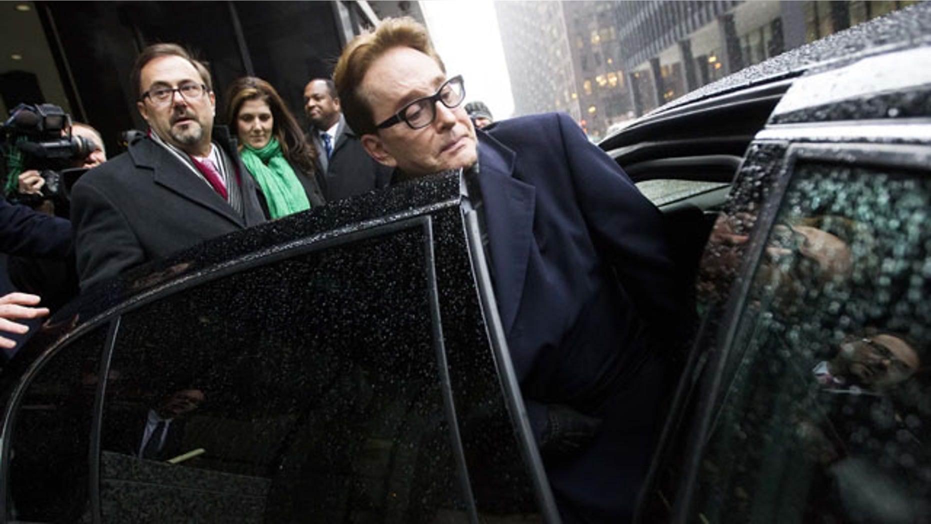 January 14, 2014: H. Ty Warner, the billionaire who created Beanie Babies, gets into a car outside the federal building in Chicago after being sentenced to two years of probation, but no prison time, for tax evasion on $25 million in income he had in Swiss bank accounts. (AP Photo/Andrew A. Nelles)