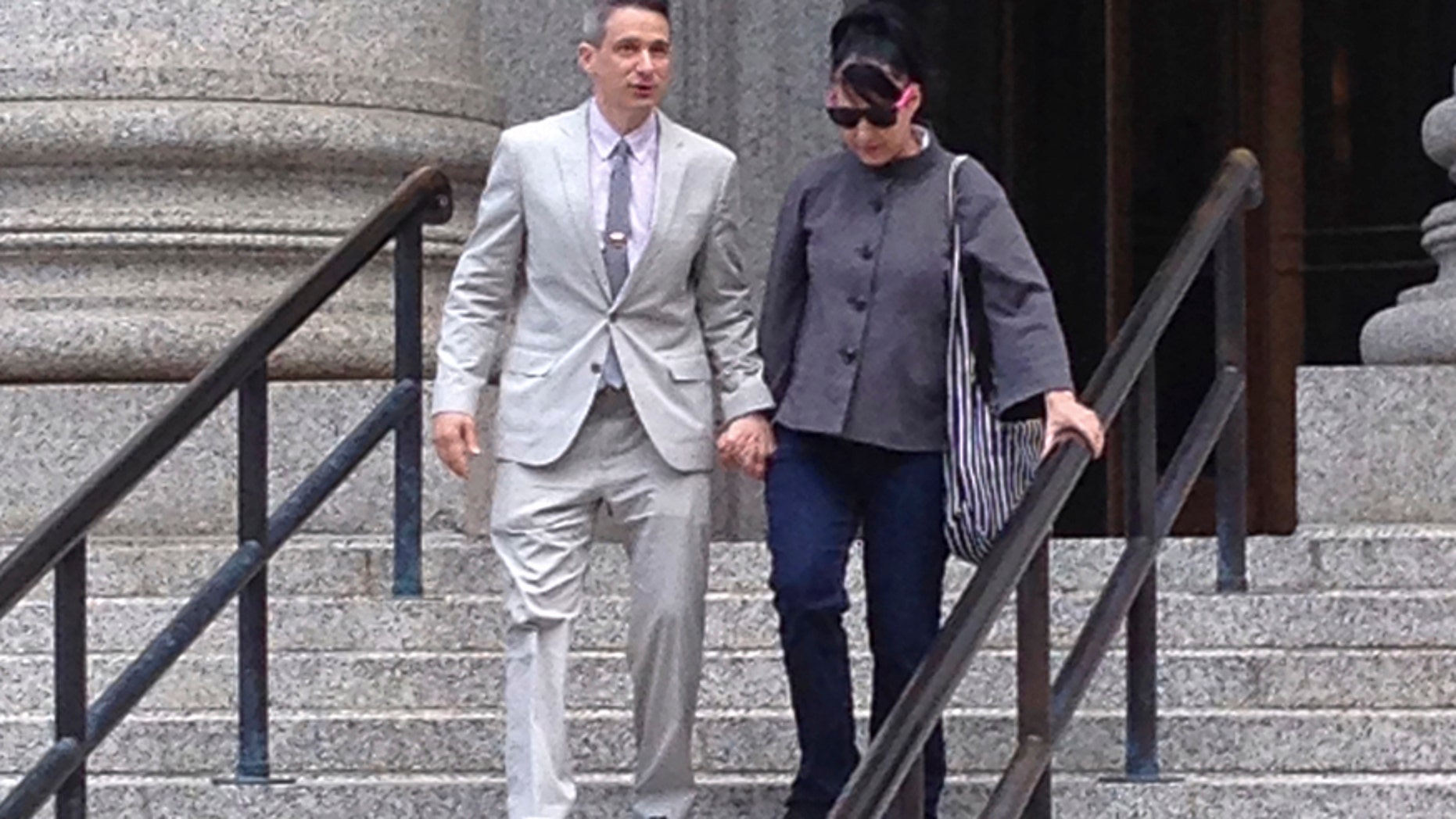 FILE - In this Tuesday, May 27, 2014 file photo, Beastie Boys rapper Adam "Ad-Rock" Horovitz leaves federal court in Manhattan with his wife Kathleen Hanna after testifying at a copyright trial stemming from a lawsuit his musical group brought against a beverage maker over the use of five of their songs in a video, in New York. The Beastie Boys want to force the maker of Monster Energy drink to pay nearly $2.4 million in legal fees and costs so the rappers $1.7 million jury award is not dwarfed by expenses in a copyright violation case, lawyers say. A Manhattan federal court jury awarded the group most of the $2 million it requested at a 2014 trial, but that was not enough to cover costs that lawyers said were worsened by the actions of the Corona, California-based Monster Energy Co., the musicians lawyers said in papers filed in Manhattan federal court.