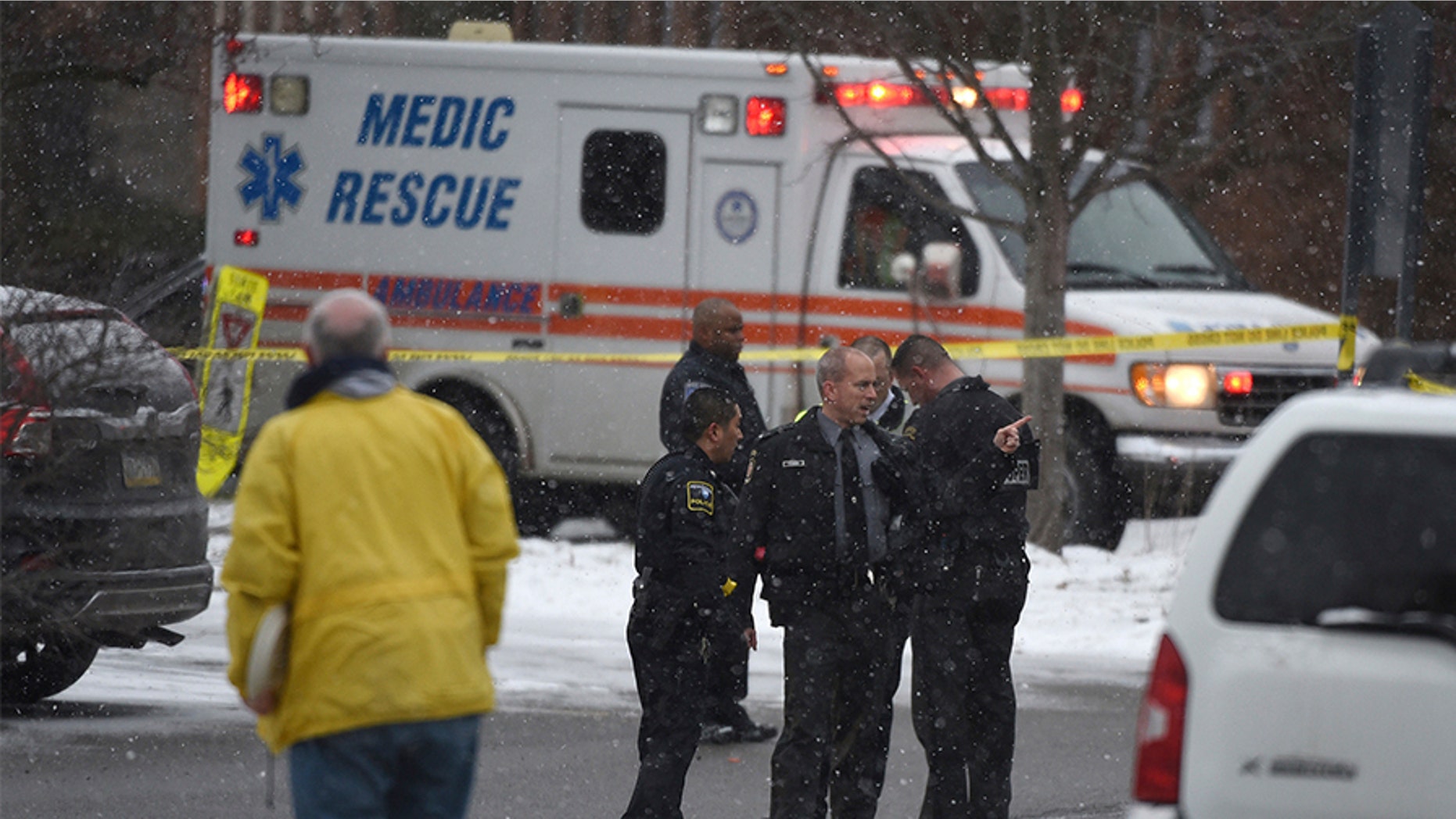 Authorities investigate the scene of a shooting at the Penn State University campus in Beaver County in Monaca, Pa., Wednesday, Dec. 13, 2017. Police say a woman who worked at a Penn State satellite campus was apparently shot dead in the university parking lot by her estranged husband and the man then killed himself. (Kevin Lorenzi/Beaver County Times via AP)