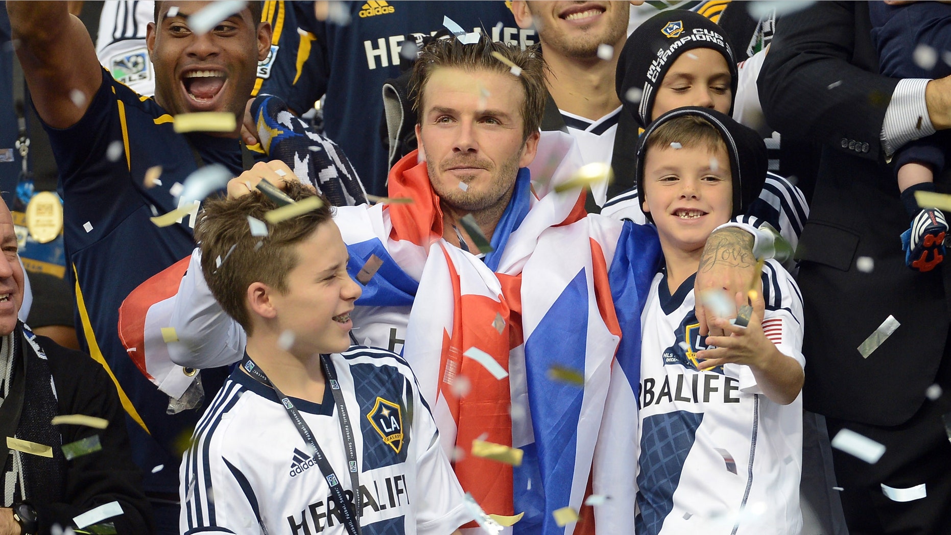 David Beckham #23 of Los Angeles Galaxy celebrates with his sons Brooklyn Beckham, Romeo Beckham and Cruz Bekham after the Galaxy defeat the Houston Dynamo 3-1 to win the 2012 MLS Cup at The Home Depot Center on December 1, 2012 in Carson, California. (Photo by Harry How/Getty Images)
