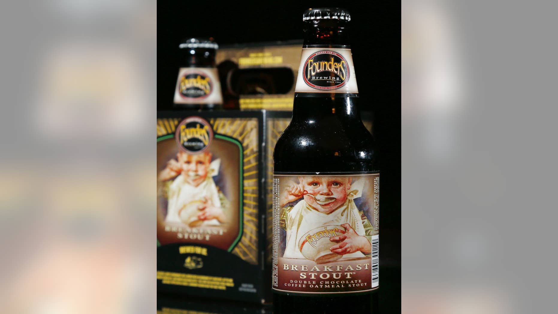 FILE - In this Jan. 15, 2015 file photo, bottles of founders Brewing Breakfast Stout are displayed in North Andover, Mass. New Hampshire Gov. Maggie Hassan on Tuesday, June 2, 2015, vetoed a measure that would have allowed some images of minors to grace alcoholic beverage labels in the state as long as they didn't encourage young people to drink. State Rep. Keith Murphy, who runs a popular tavern, sponsored the bill because he wanted to be able to buy Breakfast Stout, crafted by Founders Brewery Co. in Grand Rapids, Mich. (AP Photo/Elise Amendola, File)