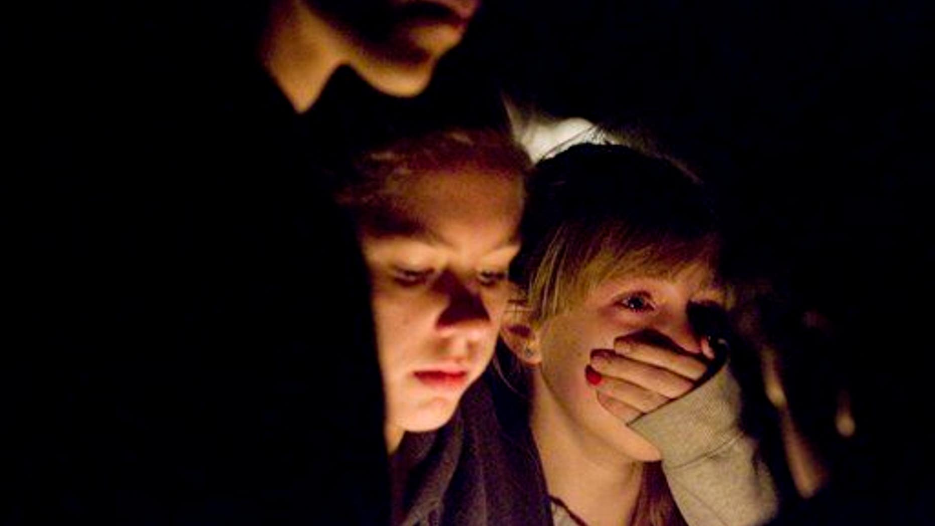 Students become emotional during a vigil for a student who died in an apparent suicide.