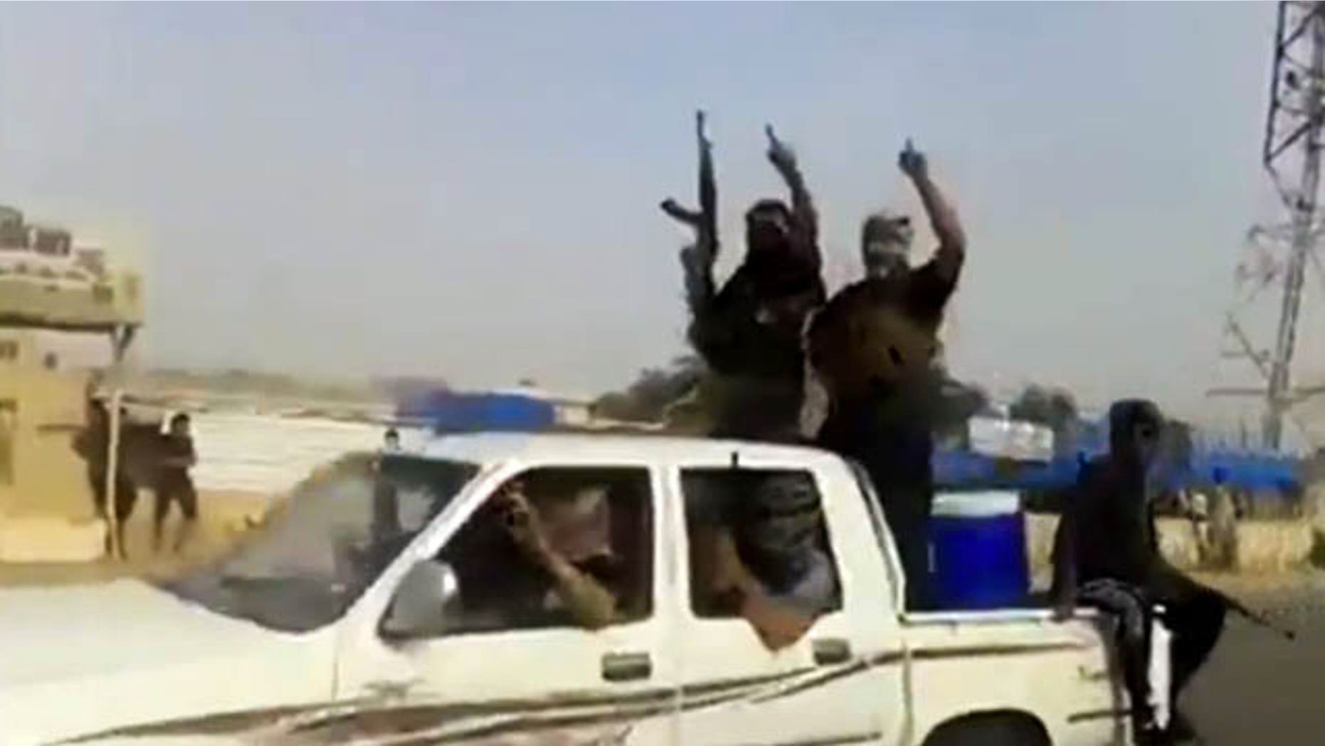 June 17, 2014: In this image taken from video uploaded to a militant social media account, which has been authenticated based on its contents and other AP reporting, Al Qaeda-inspired Islamic State of Iraq and the Levant militants arrive to Iraq's largest oil refinery in Beiji, some 155 miles north of Baghdad. (AP Photo via militant video)