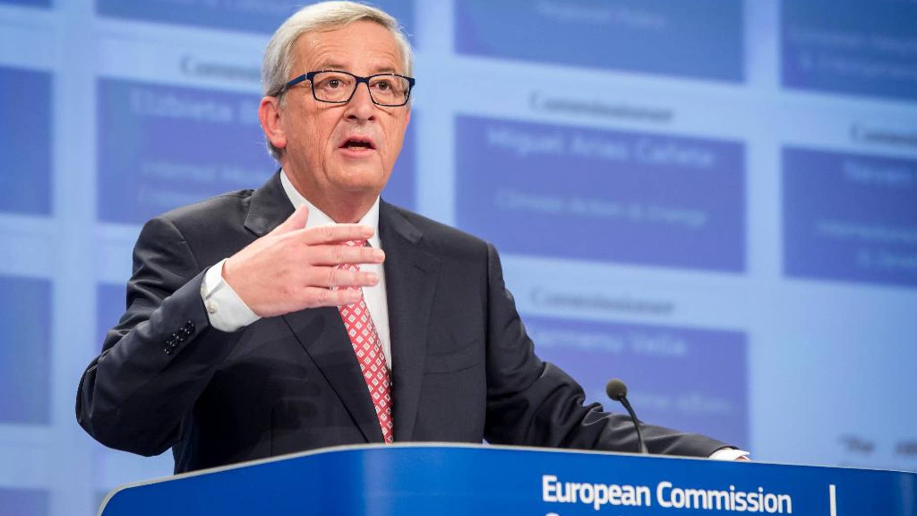 European Commission President elect Jean-Claude Juncker gestures as he addresses the media on the attribution of portfolios to the Commissioners-designate at the European Commission headquarters in Brussels on Wednesday, Sept. 10, 2014. (AP Photo/Geert Vanden Wijngaert)