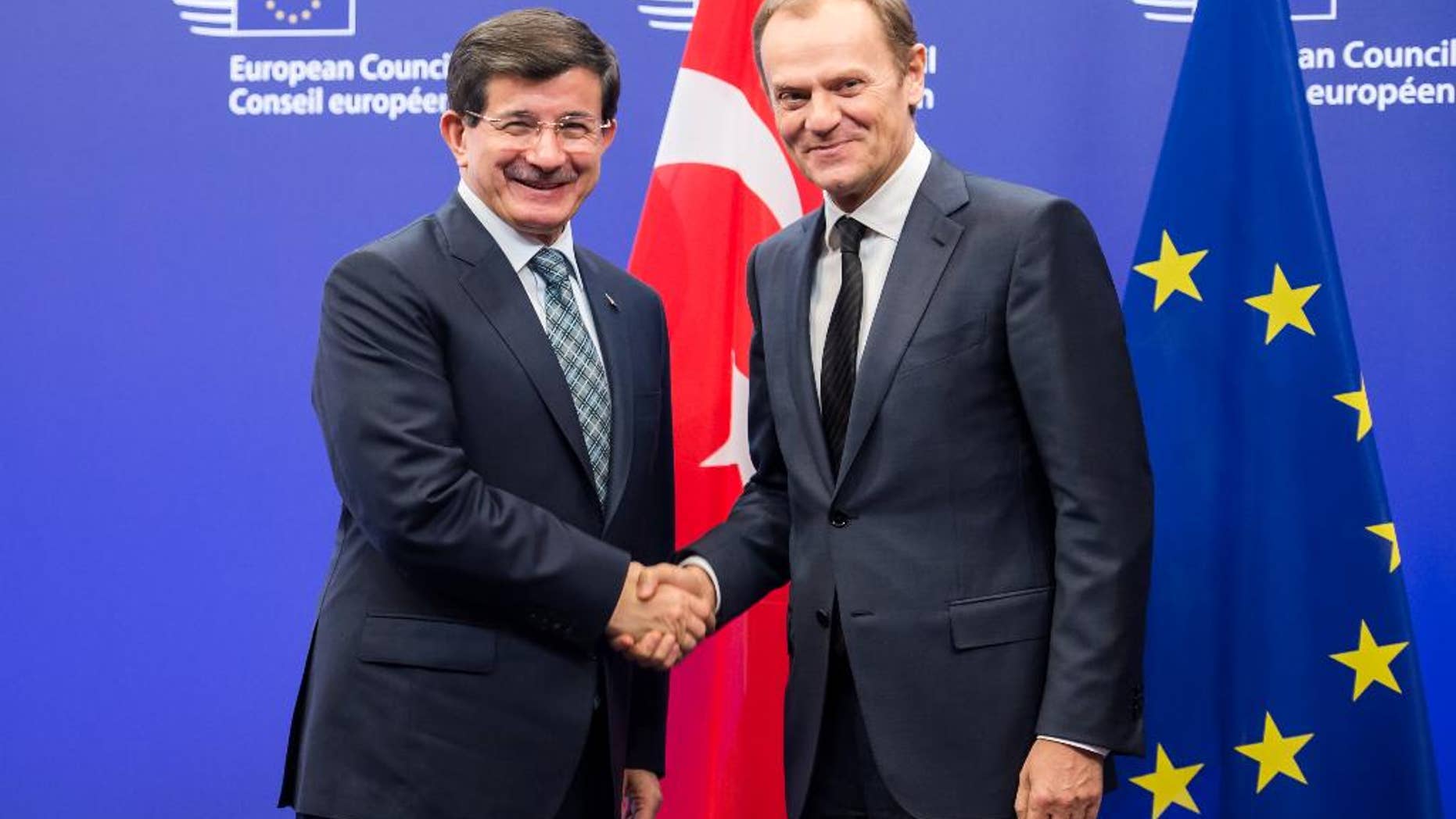 European Council President Donald Tusk, right, welcomes Turkey's Prime Minister Ahmet Davutoglu upon his arrival at the EU Council in Brussels on Thursday, Jan. 15, 2015. (AP Photo/Geert Vanden Wijngaert)