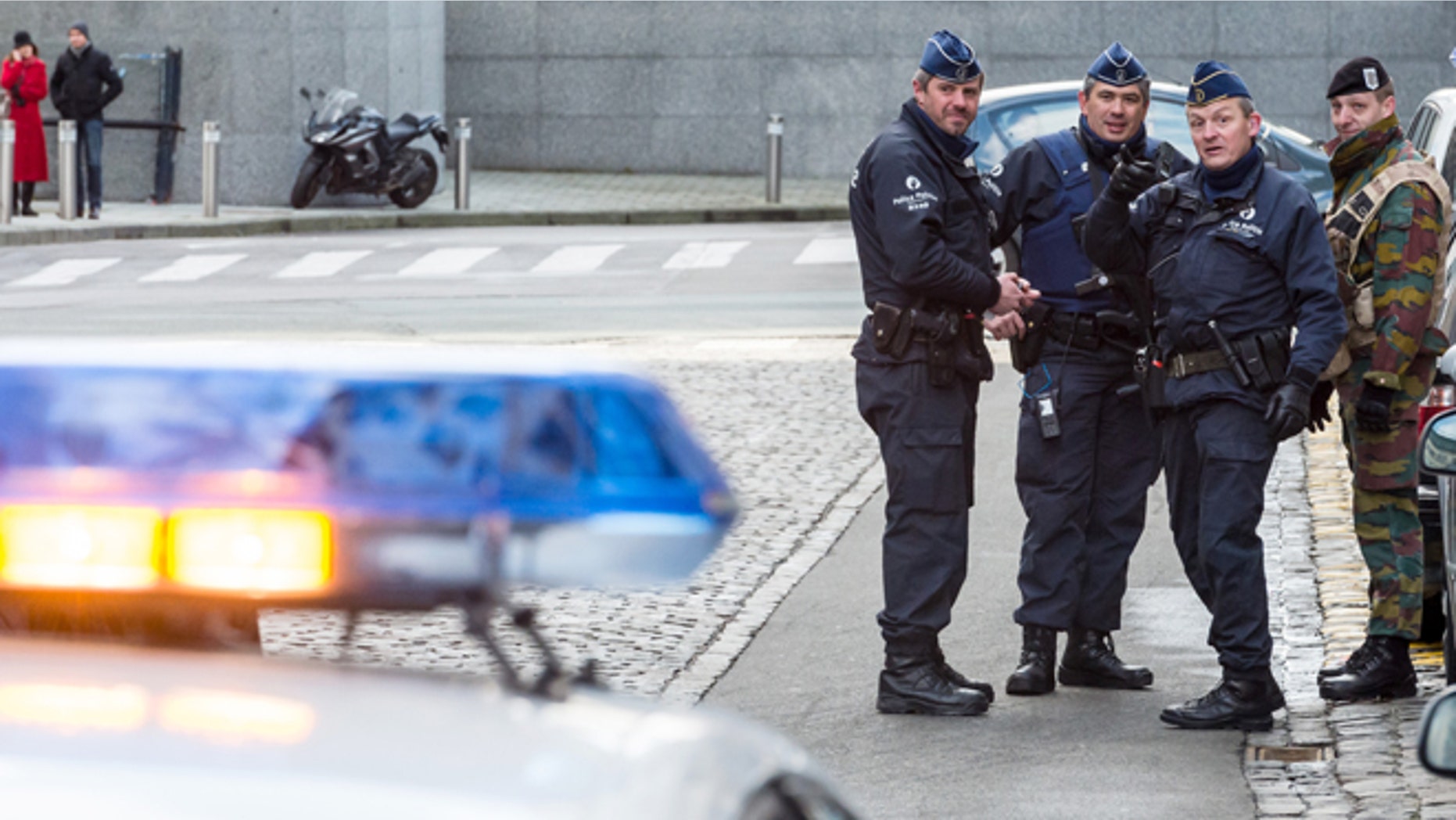 Feb. 2, 2015: Policemen and a security officer stand outside a European Parliament building in Brussels. (AP)