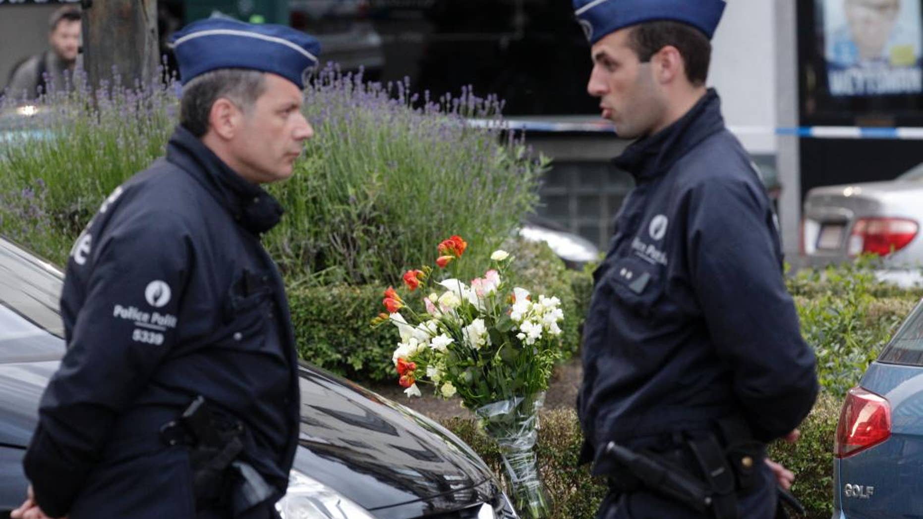 Some flowers were put close to the site of a shooting at the Jewish museum in Brussels, Saturday, May 24, 2014. Three people were killed and one seriously injured in a spree of gunfire at the Jewish Museum in Brussels on Saturday, officials said. The attack, which came on the eve of national and European Parliament elections, led officials to raise anti-terror measures.(AP Photo/Yves Logghe)