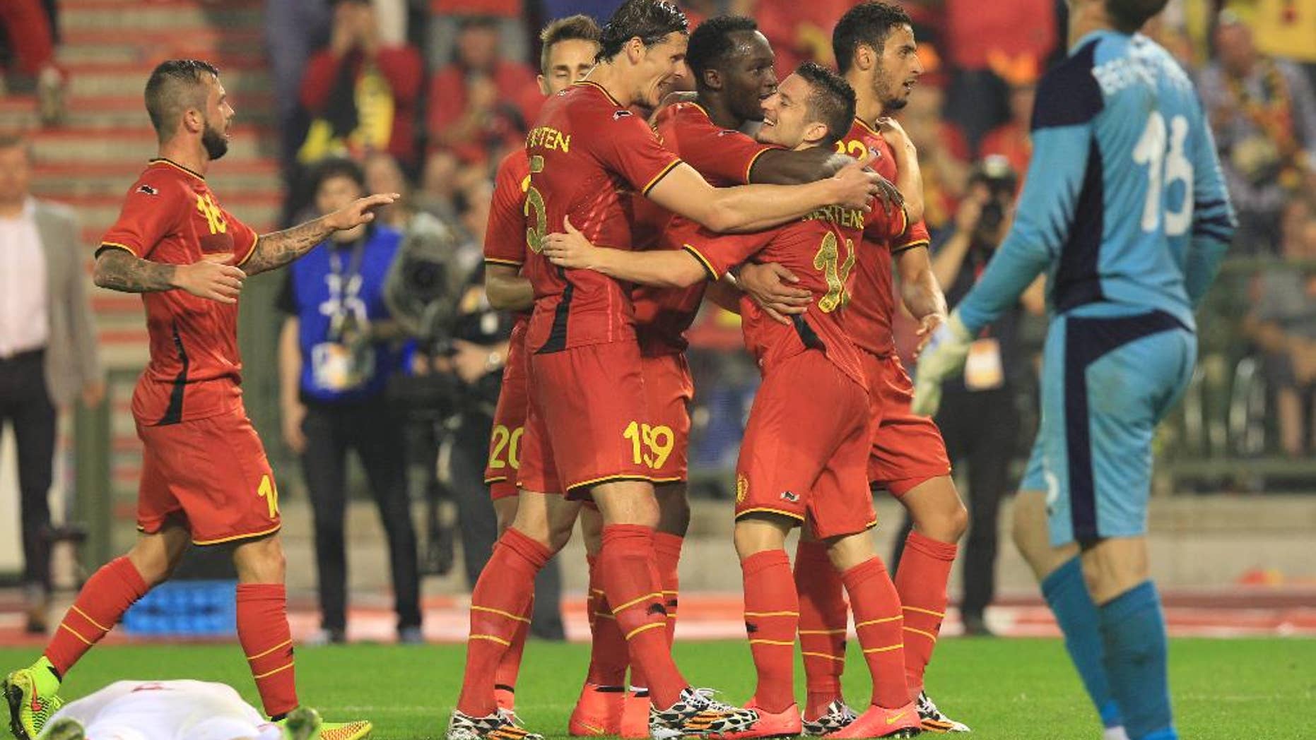 Belgium's Dries Mertens, right, gets congratulations by his team after he scored during a friendly soccer match against Tunisia, at the King Baudouin stadium in Brussels, Saturday, June 7, 2014. Belgium will play against South Korea, Russia and Algeria in Group H of the World Cup 2014 in Brazil. (AP Photo/Yves Logghe)