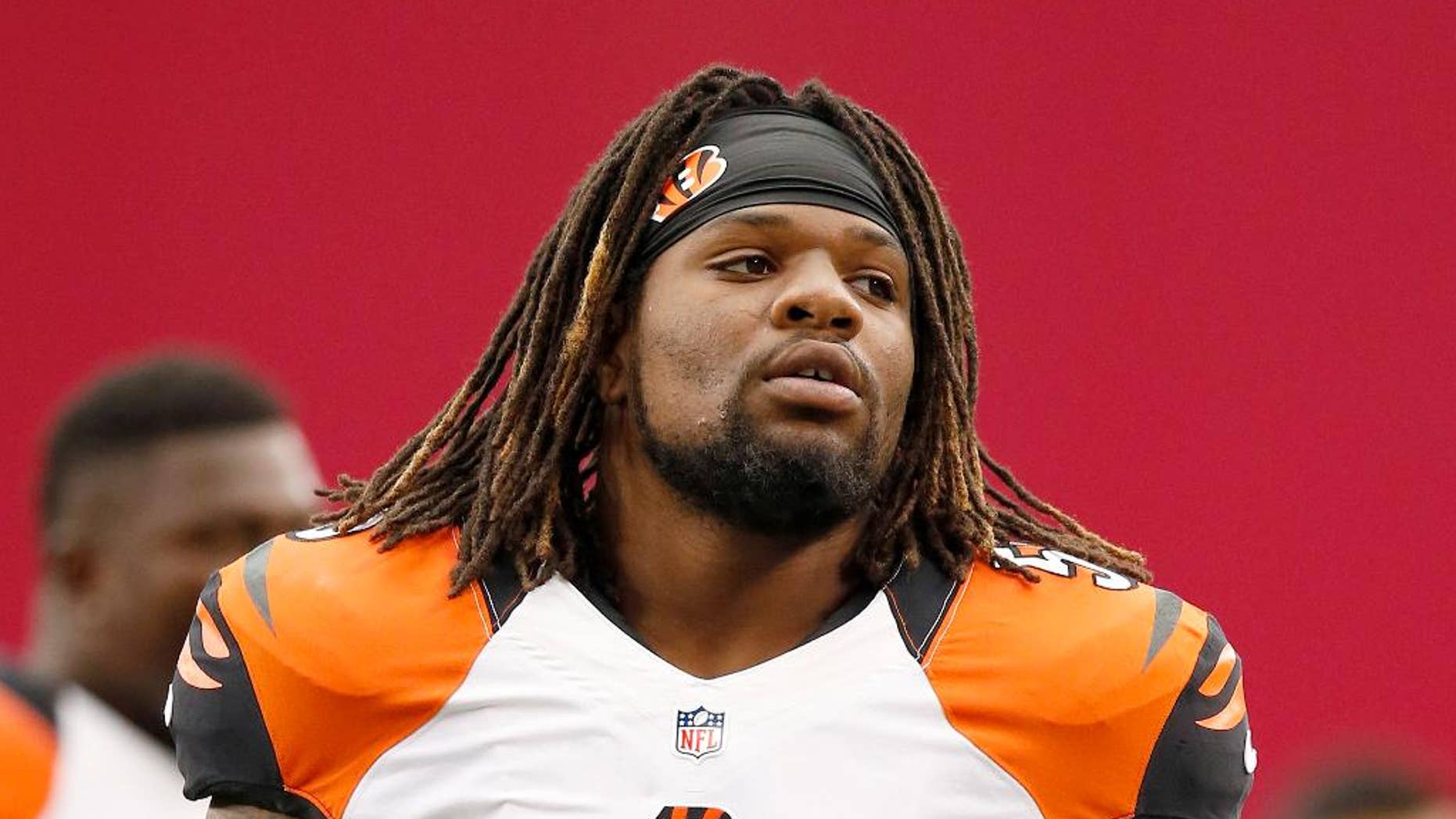 FILE - In this Aug. 24, 2014, file photo, Cincinnati Bengals' Vontaze Burfict stretches out with teammates prior to an NFL preseason football game against the Arizona Cardinals in Glendale, Ariz. Burfict had surgery to clean out his left knee on Wednesday, Oct. 29, 2014, and will miss at least the next two games. (AP Photo/Ross D. Franklin, File)
