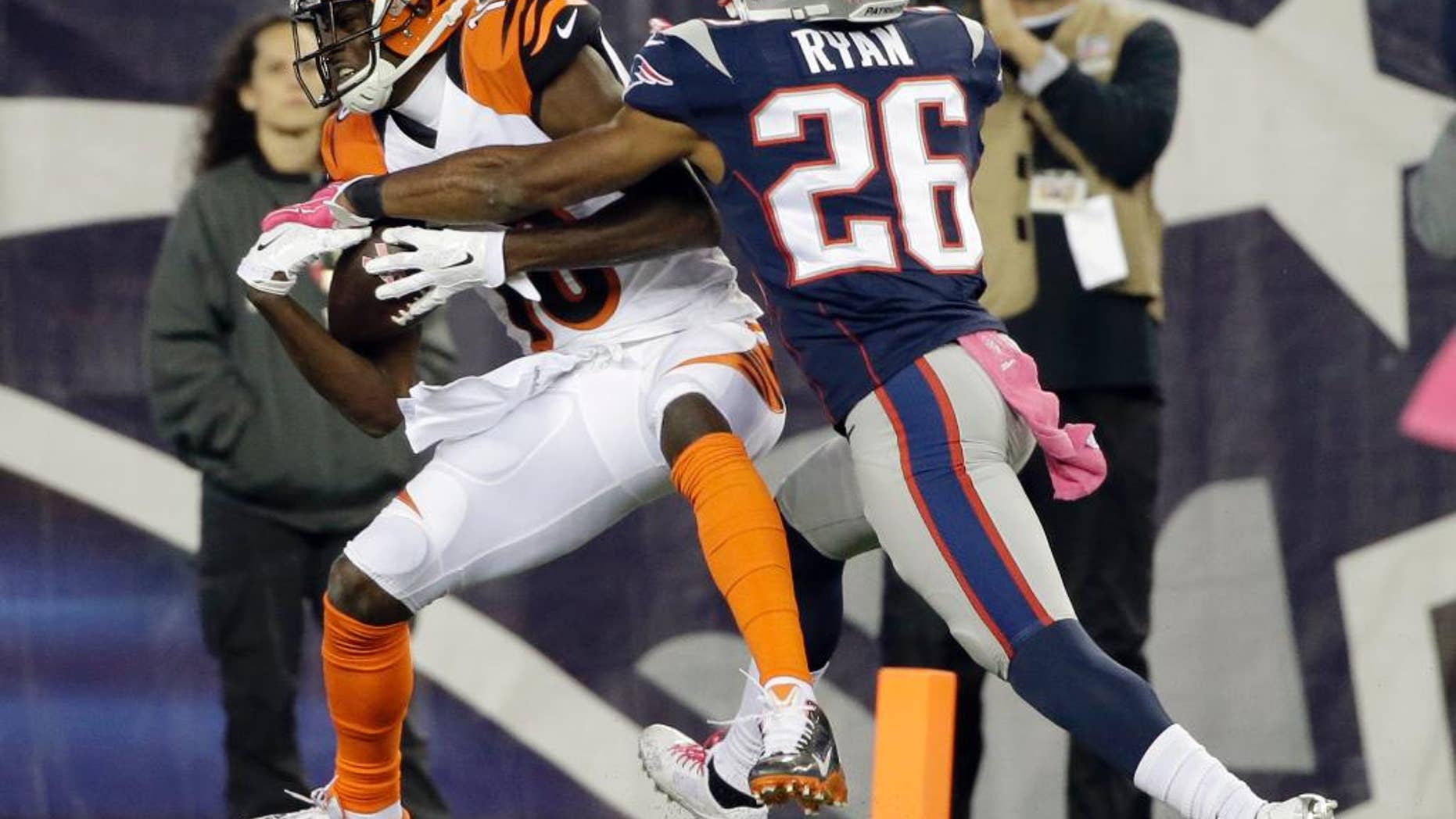 Cincinnati Bengals wide receiver A.J. Green (18) catches a touchdown pass in front of New England Patriots cornerback Logan Ryan (26) in the second half of an NFL football game Sunday, Oct. 5, 2014, in Foxborough, Mass. (AP Photo/Steven Senne)