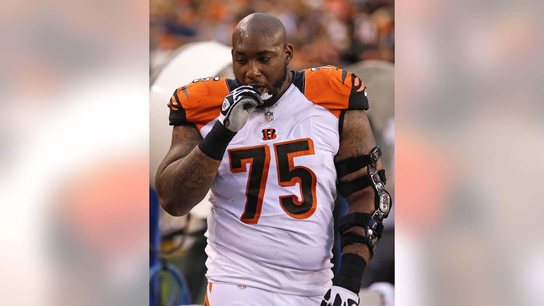 This photo made Aug. 16, 2014, shows Cincinnati Bengals defensive tackle Devon Still on the sidelines during an NFL preseason football game against the New York Jets in Cincinnati. Still is grateful to be on the Bengals' practice squad, which allows him to keep his medical insurance. His 4-year-old daughter is fighting cancer. (AP Photo/Tony Tribble)