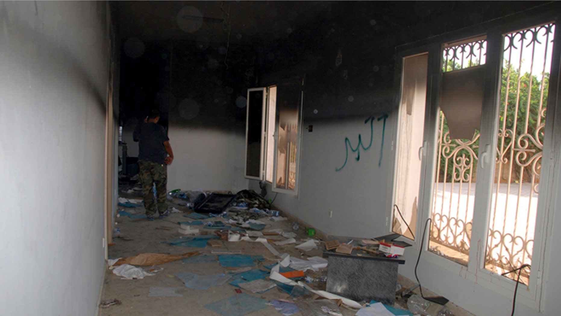 Sept. 12, 2012: This file photo shows a man walking through a room in the gutted U.S. consulate in Benghazi, Libya, after an attack that killed four Americans, including Ambassador Chris Stevens.
