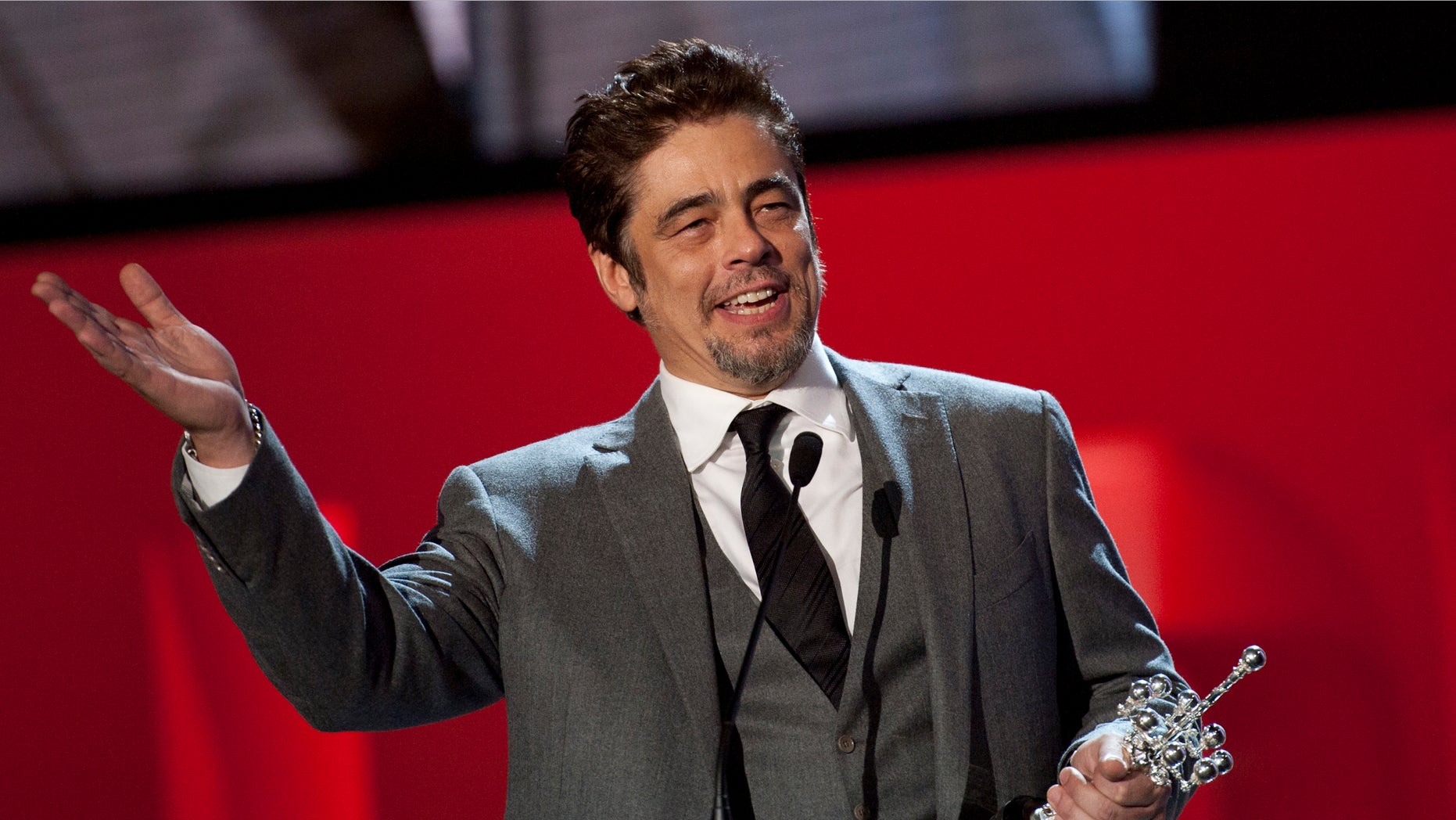Puerto Rican born actor Benicio del Toro shows his trophy after receiving the Donostia Award for his contribution for the cinema, at the 62nd San Sebastian Film Festival, in San Sebastian, northern Spain, Friday, Sept. 26, 2014. The festival is one of the most prestigious and internationally recognised in Spain. (AP Photo/Alvaro Barrientos)