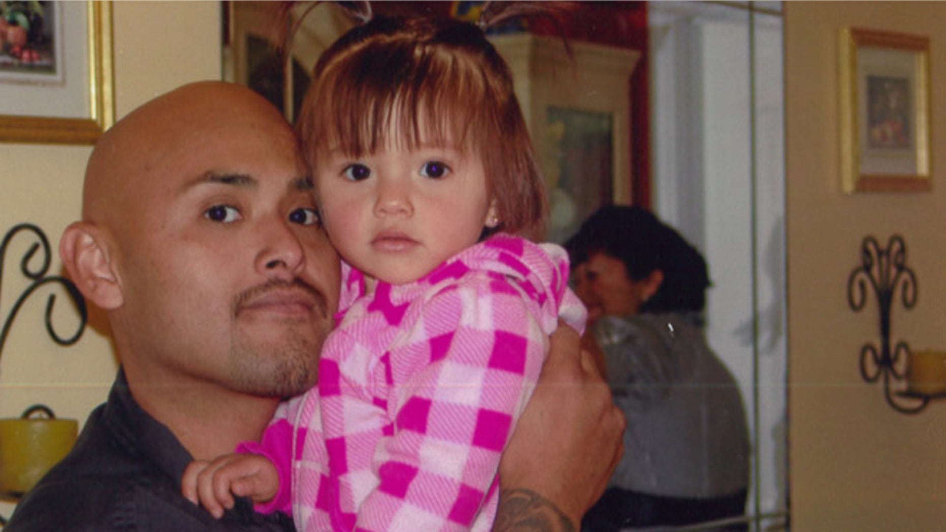 This undated photo provided by Galipo Law shows Benny Herrera holding his daughter, Abygail. A federal appeals court says a dashboard video shows a California police officer shooting and killing a man less than a second after ordering him to show his hands. The court noted the video footage Friday, Sept. 16, 2016, in rejecting Tustin Police Officer Osvaldo Villareal's request to dismiss the wrongful death lawsuit against him. The 9th U.S. Circuit Court of Appeals in San Francisco said Villareal couldn't have reasonably feared for his safety when he shot Herrera in December, 2011. (Galipo Law via AP)