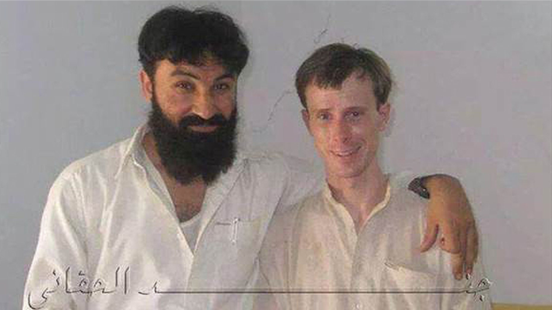 In this undated photo provided my MEMRI, Sgt. Bowe Bergdahl is seen posing with a senior member of the Haqqani network in Afghanistan during his five years in captivity.