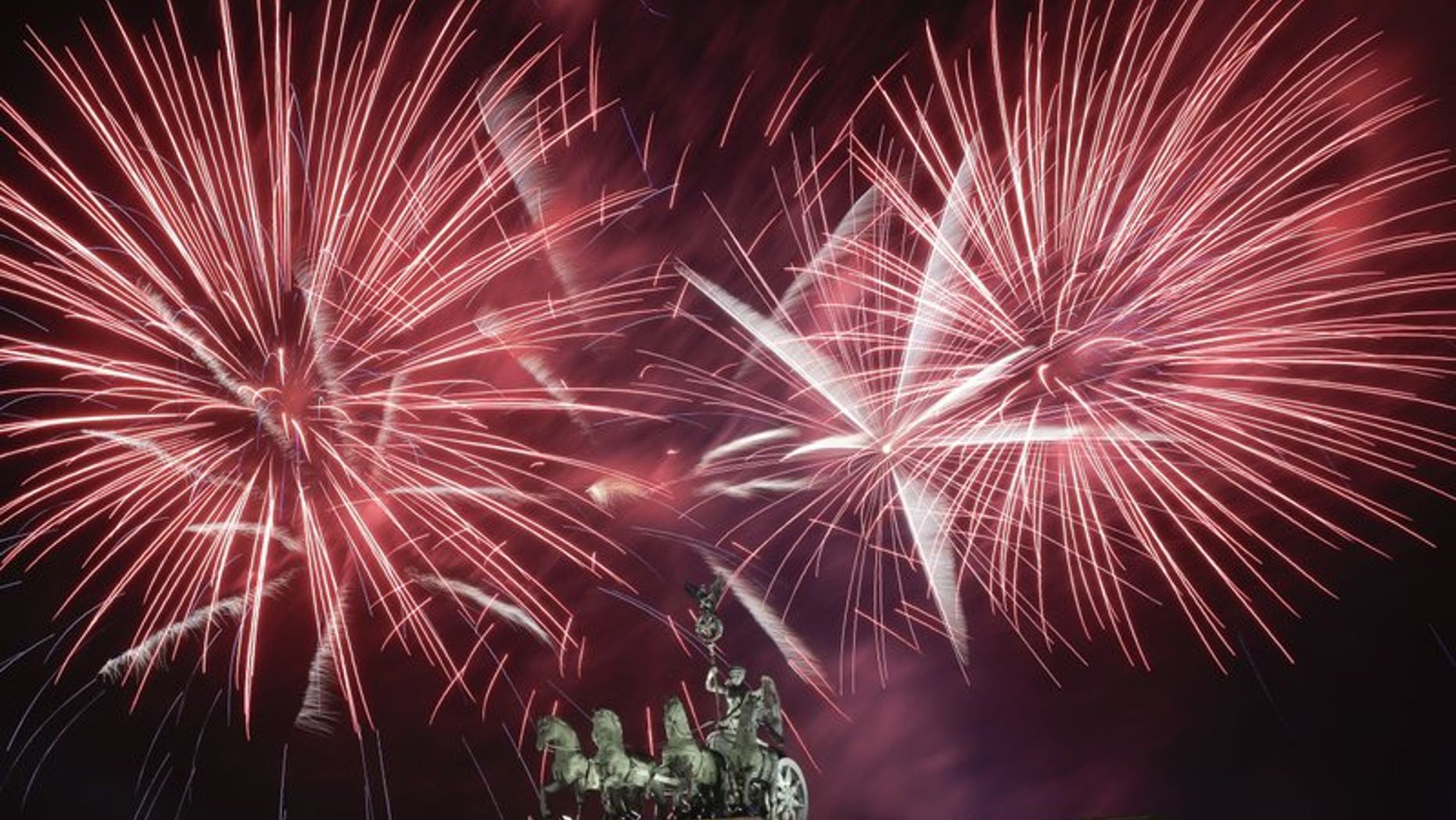 Hundreds of thousands of revelers watched the fireworks display above the Quadriga at the Brandenburg Gate in Berlin, Germany.