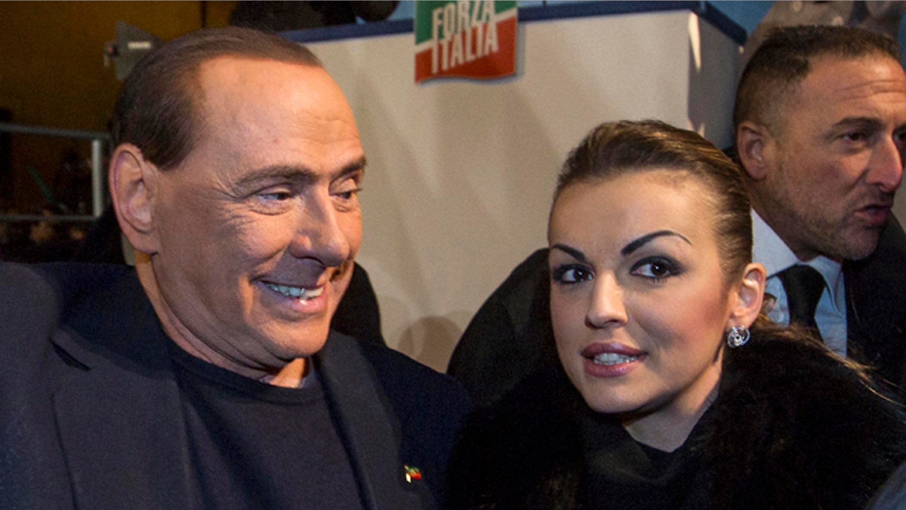 Nov. 27, 2013: Silvio Berlusconi, left, is flanked by his girlfriend Francesca Pascale as he leaves after addressing a rally in Rome.