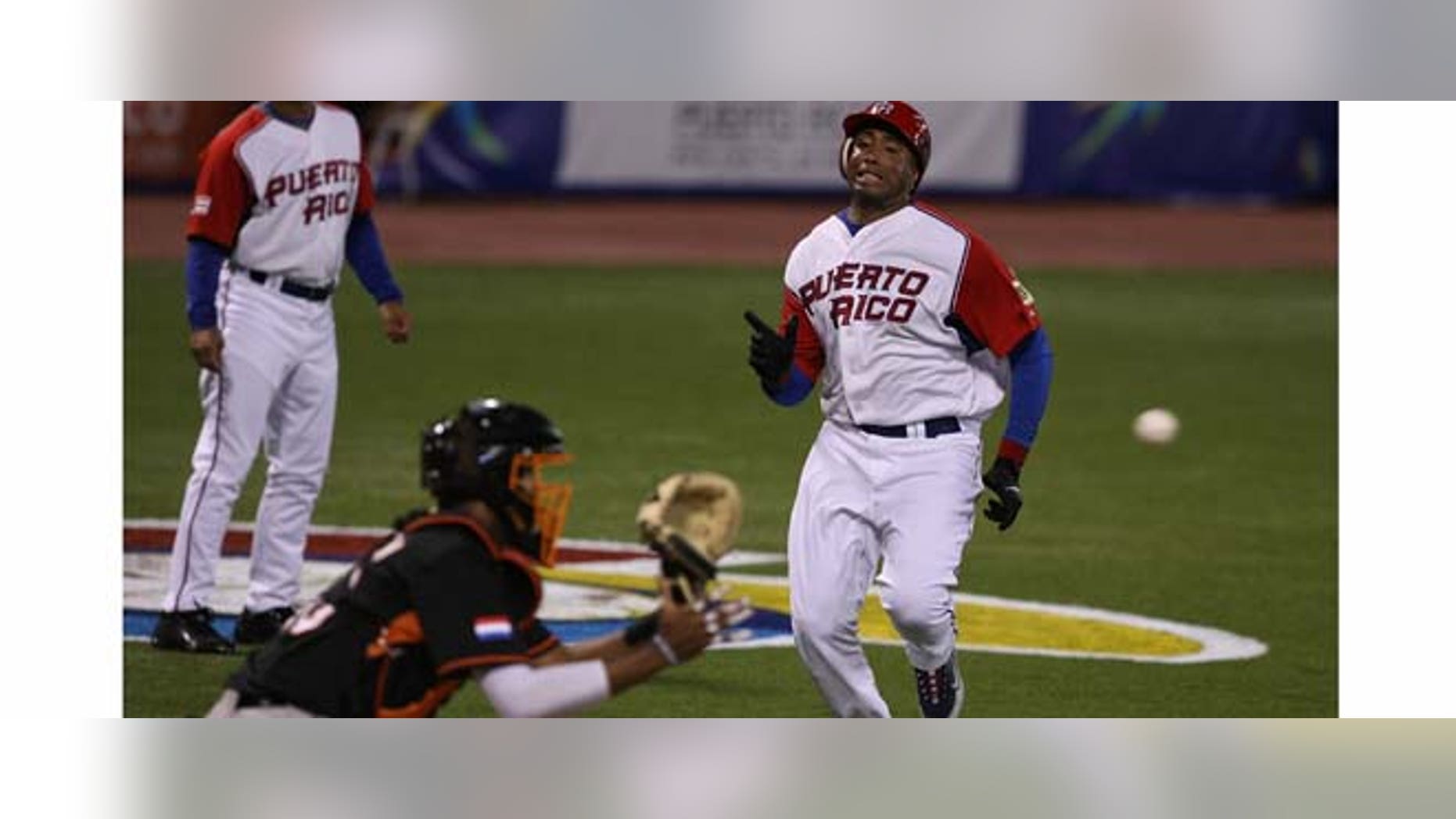 SAN JUAN, PUERTO RICO - MARCH 09: Bernie Williams #51 of Puerto Rico is tagged out at the plate by Kenley Jansen #50 of The Netherlands during the 2009 World Baseball Classic Pool D match on March 9, 2009 at Hiram Bithorn Stadium in San Juan, Puerto Rico. (Photo by Al Bello/Getty Images)