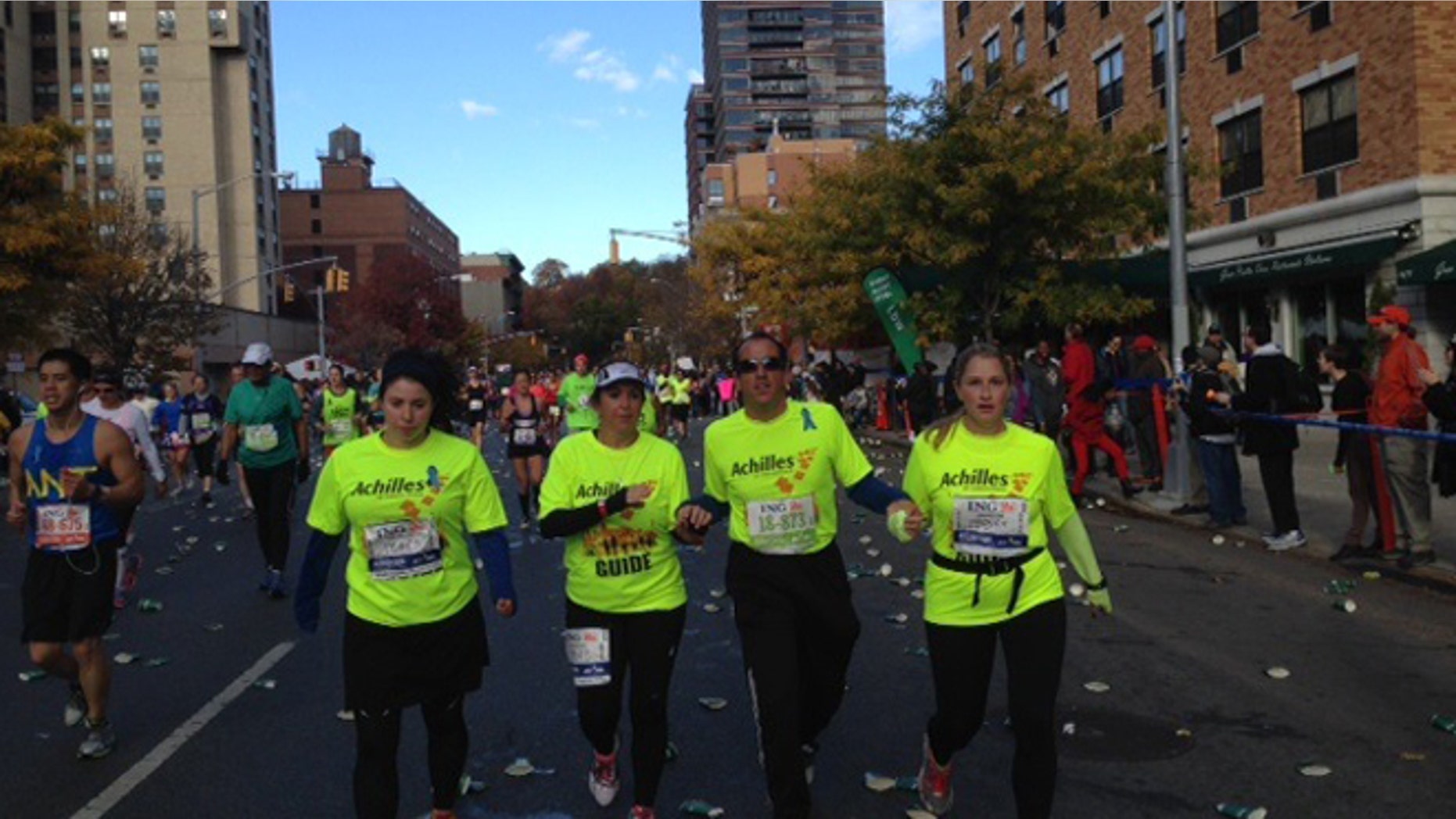 Richard Bernstein running the New York City marathon on Sunday, November 3, accompanied by guides from Achilles International.
