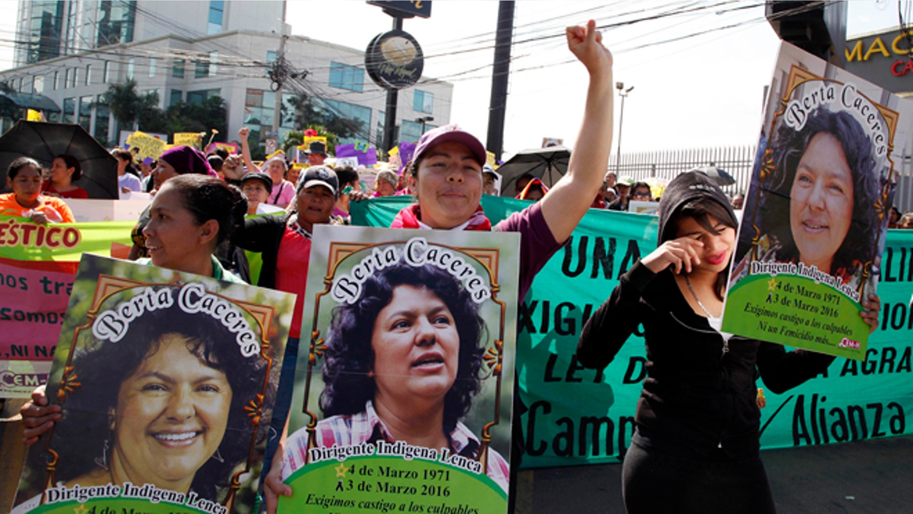 Women carry images of slain environmental activist Berta Caceres during the commemoration of International Women's Day in Tegucigalpa, Honduras, Tuesday, March 8, 2016. Caceres, a Lenca Indian activist who won the 2015 Goldman Environmental Prize for her role in fighting a dam project was killed by unknown assailants on March 3, 2016. She had previously complained of receiving death threats from police, soldiers and local landowners because of her work. (AP Photo/Fernando Antonio)