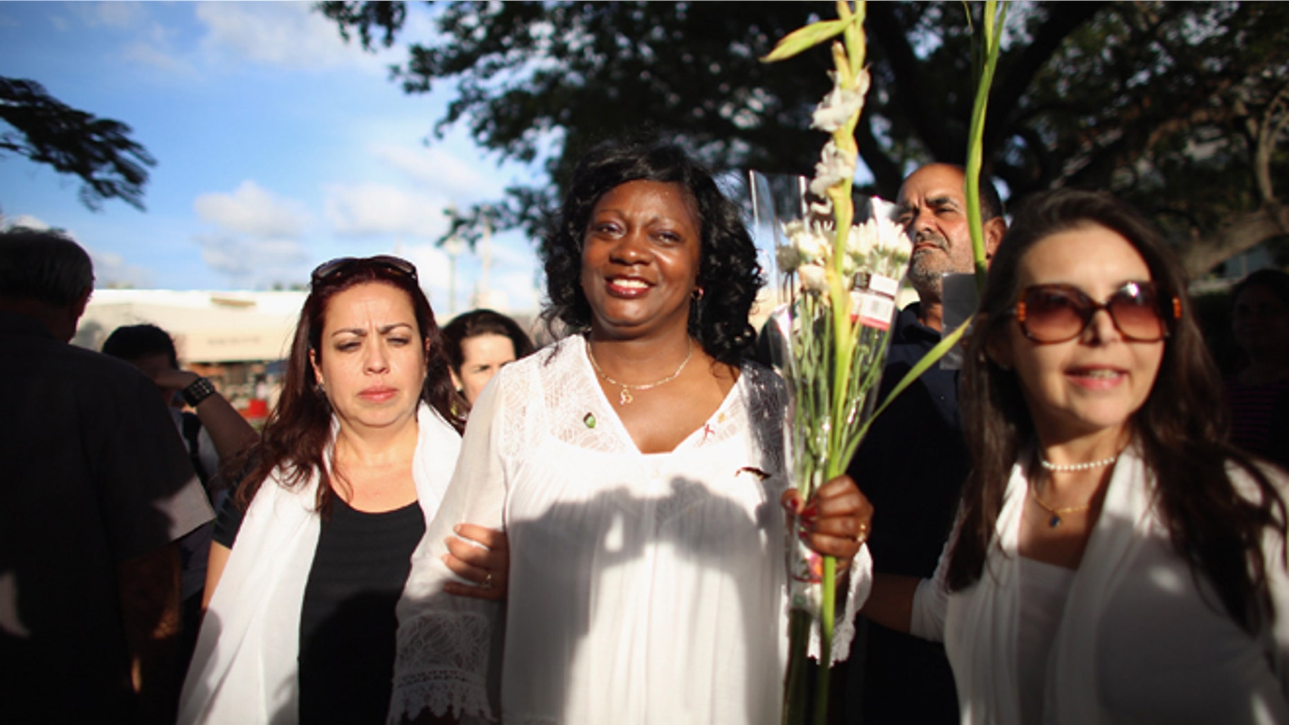 CORAL GABLES, FL - APRIL 27: Berta Soler, co-founder of the Ladies in White, (C) and current leader of the Cuban opposition group walks with Janisset Rivero (L) and others as she visits with Cuban exiles during an event at Merrick Park on April 27, 2013 in Coral Gables, Florida. In Cuba Solerâs group is made up of wives and mothers and was formed in 2003 after the arrests of 75 government opponents. (Photo by Joe Raedle/Getty Images)