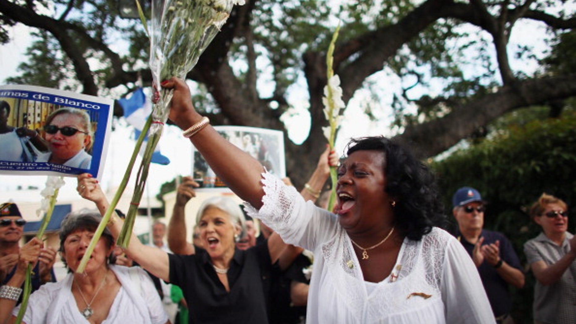 CORAL GABLES, FL - APRIL 27: Berta Soler, co-founder of the Ladies in White, and current leader of the Cuban opposition group leads a cheer as she visits with Cuban exiles during an event at Merrick Park on April 27, 2013 in Coral Gables, Florida. In Cuba Soler?s group is made up of wives and mothers and was formed in 2003 after the arrests of 75 government opponents. (Photo by Joe Raedle/Getty Images)