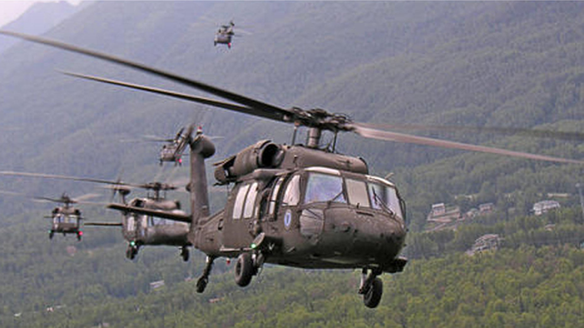 Six Alaska Army National Guard UH-60L Black Hawk helicopters bank over Eagle River Monday morning on the way to landing at Elmendorf Air Force for loading aboard heavy airlifters for transport to Iraq. A total of ten Army Guard Black Hawks from the 1-207th Aviation Battalion at Bryant Air Air Field on Ft. Richardson made the short hop Monday morning. The helicopters will be shipped to Iraq and the approximately 100 pilots and crewmembers will head out in August to rejoin their aircraft for a year-long deployment.