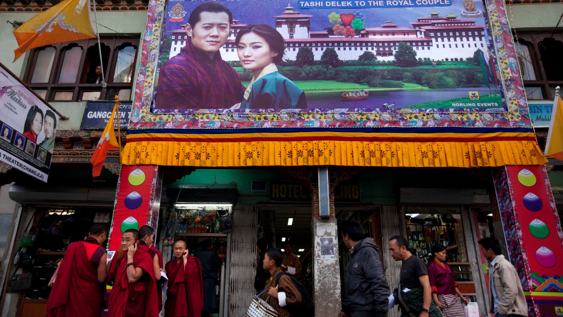 A large banner of King Jigme Khesar Namgyal Wangchuck and future Queen Jetsun Pema is seen on a storefront in the capital of Thimphu, Bhutan, Wednesday, Oct. 12, 2011. The 31 year-old reformist monarch of the small Himalayan Kingdom will wed his commoner bride in a series ceremonies set for Thursday.