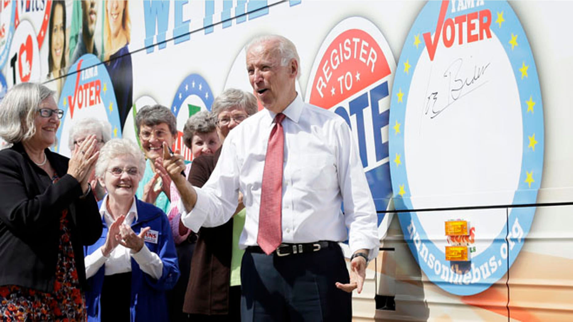 Sept. 17, 2014: Vice President Joe Biden reacts after signing the Nuns on the Bus tour bus during a stop in Des Moines, Iowa.