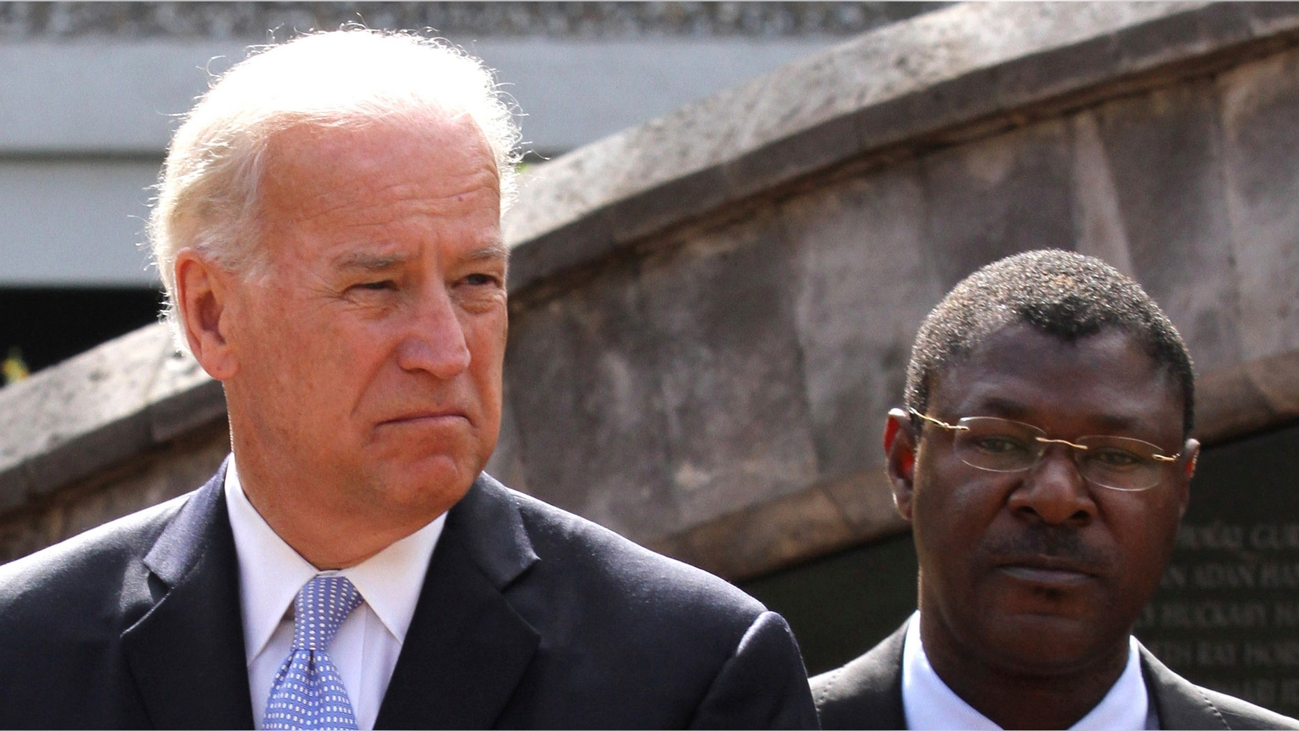 Vice President Biden and Kenyan Foreign Affairs Minister Wetangula look on after laying a wreath at the site of the former U.S. Embassy in Nairobi. While in Kenya, Biden expressed support for the proposed new constitution, which Kenya approved on Aug. 4. (Reuters)