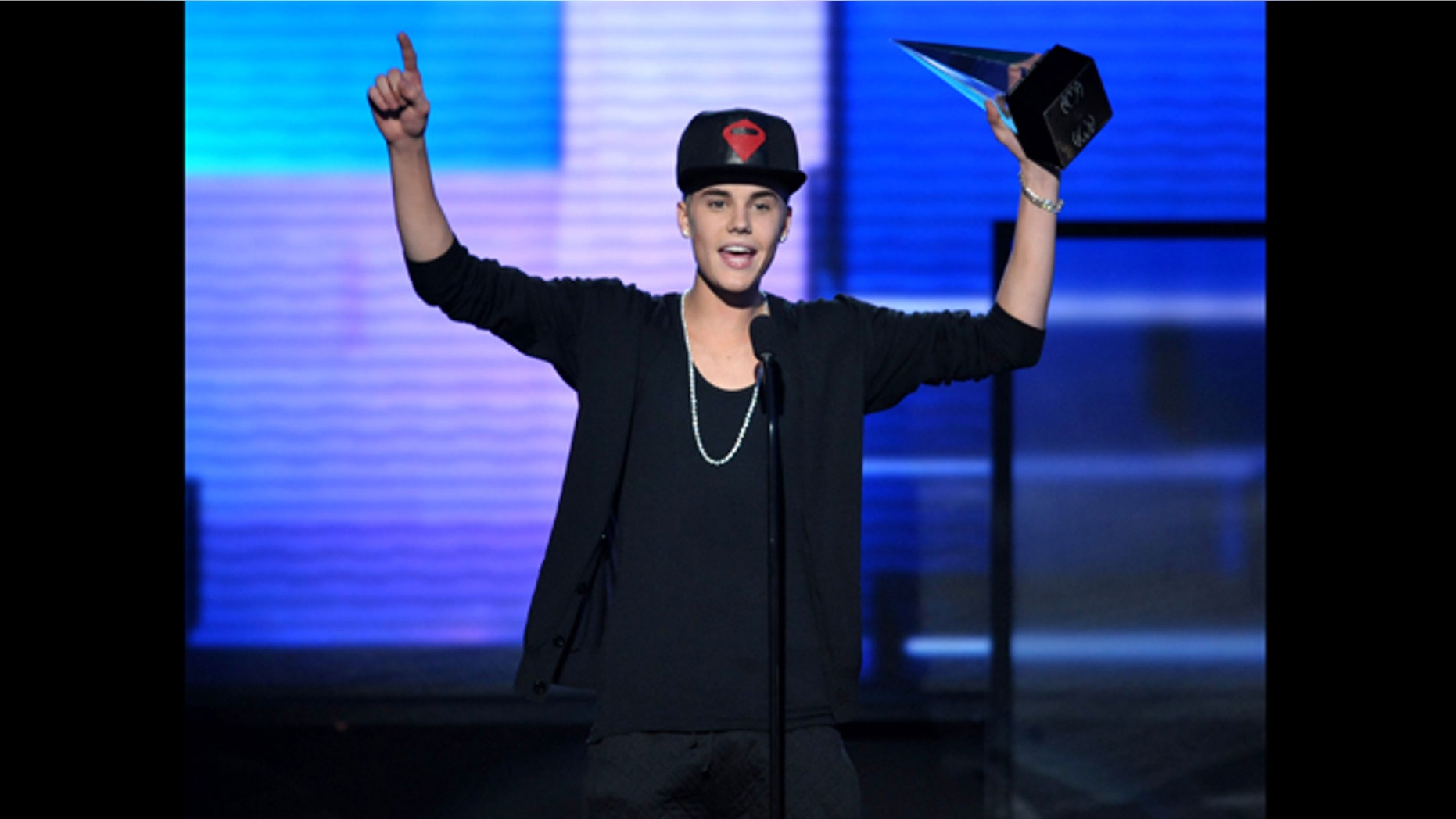 Nov. 18, 2012: File photo, Justin Bieber accepts the award for favorite album - pop/rock for "Believe" at the 40th Anniversary American Music Awards, in Los Angeles. A Los Angeles appellate panel wrote in a preliminary statement filed Monday, Jan. 28, 2013, that a 2010 California anti-paparazzi statute is constitutional. The law was used to charge a photographer for chasing Bieber last year, but a judge dismissed the anti-paparazzi counts in November 2012 because he said the law is overly broad and unconstitutional.