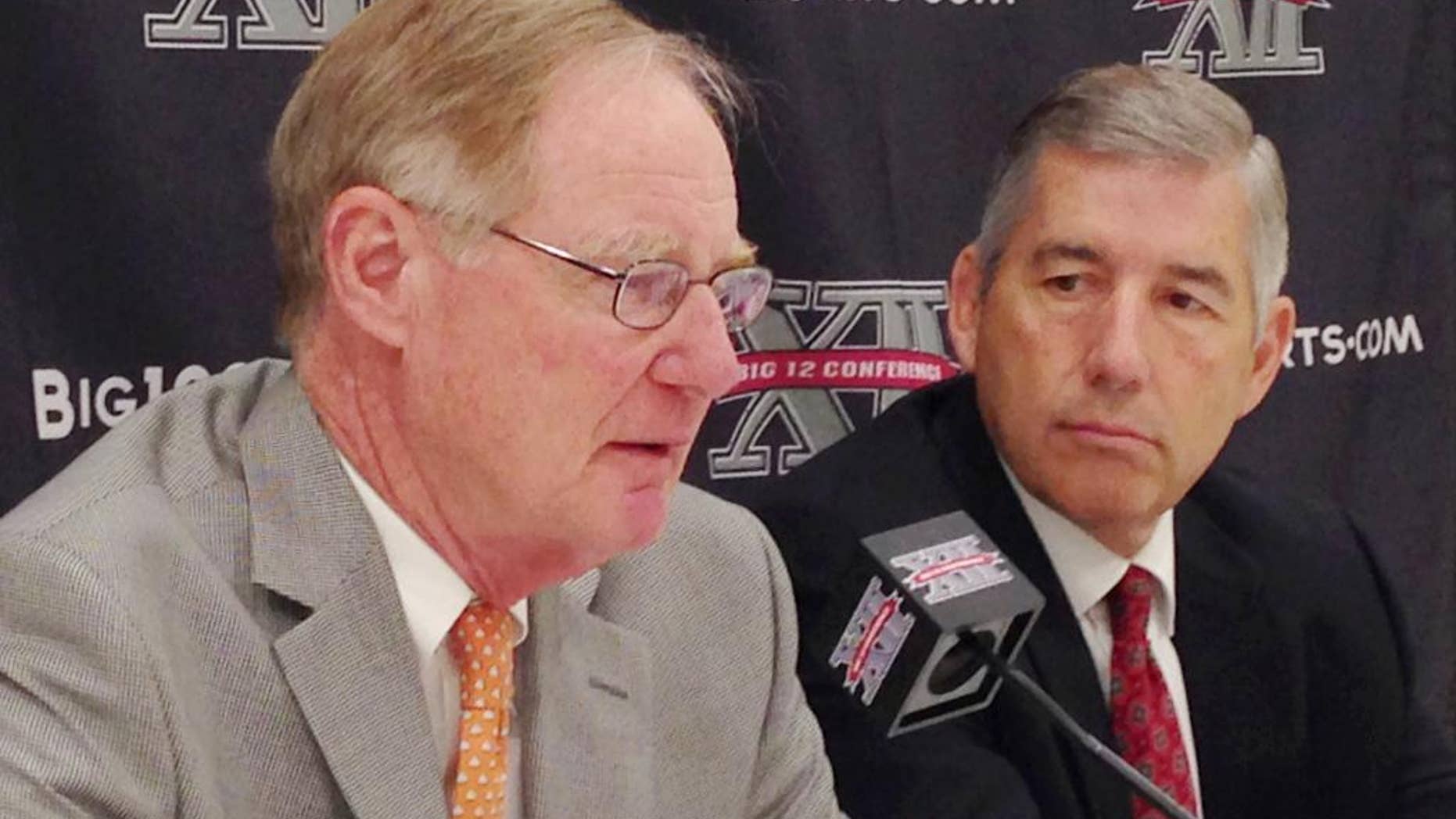 Oklahoma State President and Chairman of the Big 12 board of directors Burns Hargis, , left, and Big 12 Commissioner Bob Bowlsby, talk at the end of the Big 12 meetings at the Four Seasons Resort and Hotel in Irving, Texas, on Friday, May 30, 2014. (AP Photo/Stephen Hawkins)