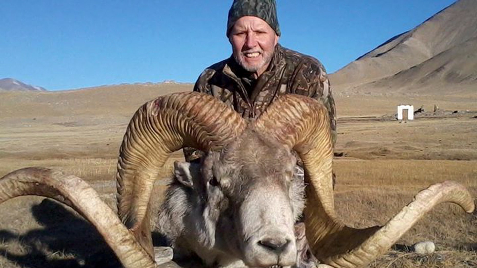 This Dec. 2012 photo provided by Rick Vukasin shows Vukasin, 65, of Great Falls, Mont., posing with a rare argali sheep known as the "Marco Polo'' that he shot in the Pamir mountains of northeast Tajikistan near Karakul Lake along the Chinese border. Vukasin filed a lawsuit in U.S. District Court in Reno on Feb. 6, 2014 against a Tajikistani guide and Canadian outfitter he accuses of defrauding him by shipping him horns taken from an animal other than the 58-inch long ones he says belonged to the sheep he shot. (AP Photo/Rick Vukasin)