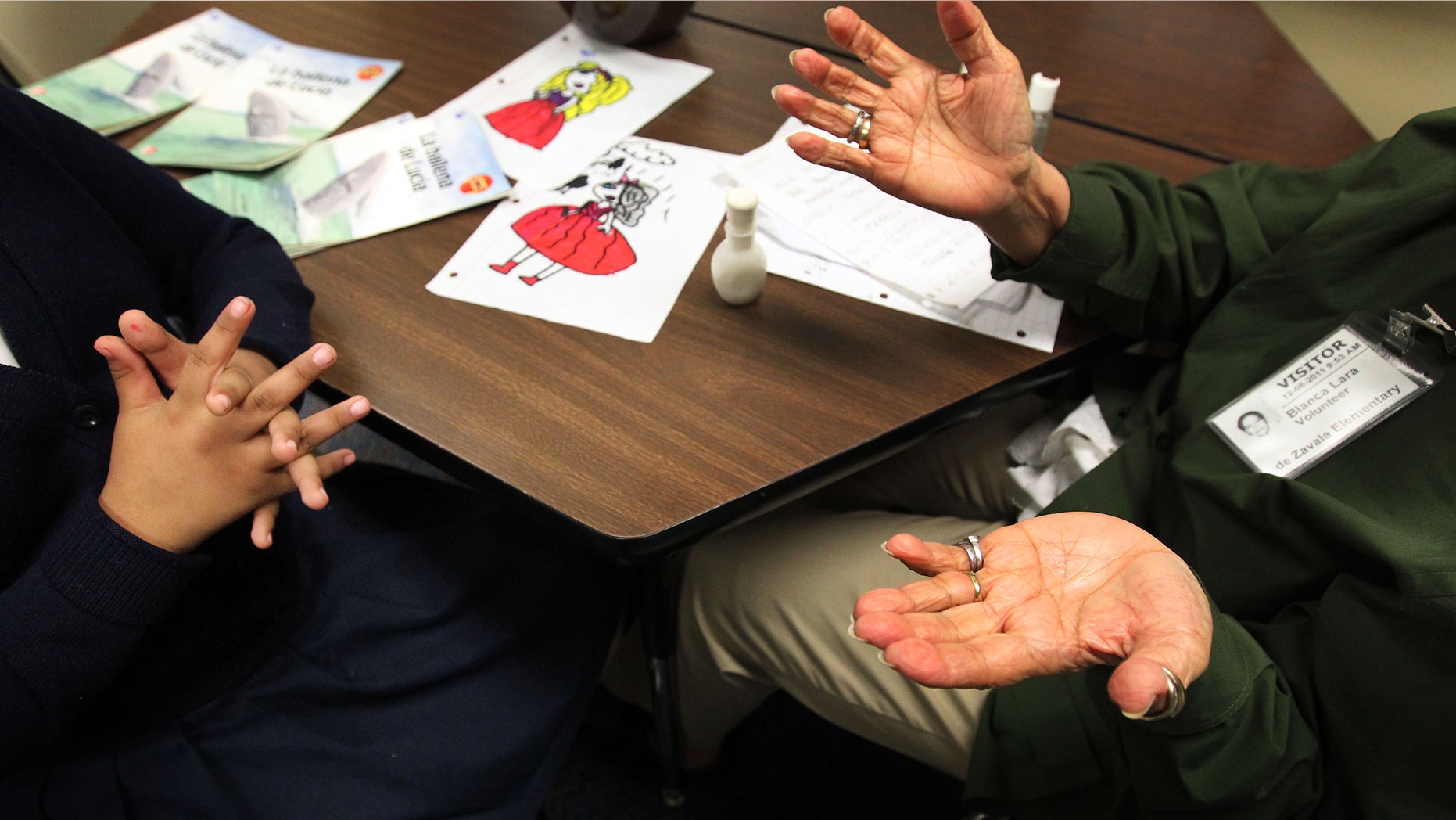 Blanca Lara, a senior volunteer, right, works with Teresa Rios, 8, left, during a tutoring session on Feb. 23, 2012 at Zavala Elementary School in Dallas, Texas. (AP Photo/The Dallas Morning News, Mona Reeder)