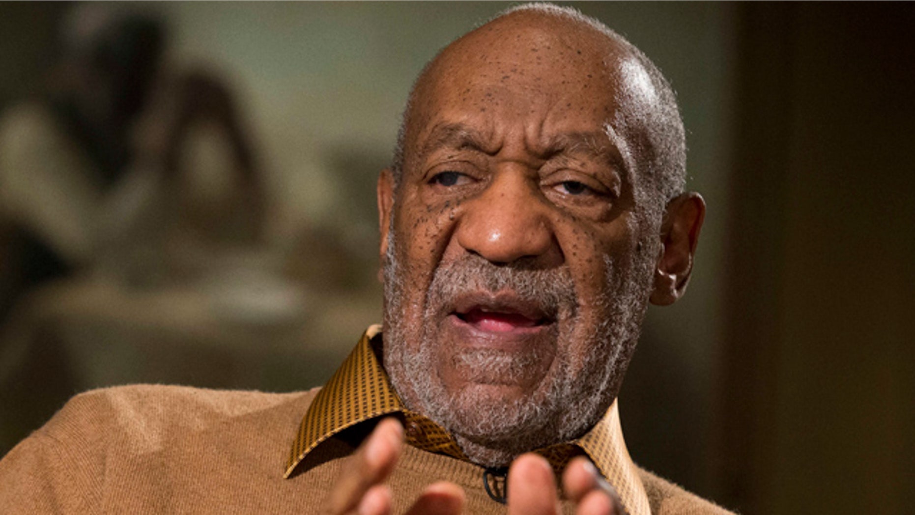 FILE - In this Nov. 6, 2014 file photo, entertainer Bill Cosby gestures during an interview about the upcoming exhibit, 'Conversations: African and African-American Artworks in Dialogue,' at the Smithsonian's National Museum of African Art, in Washington. (AP Photo/Evan Vucci, File)