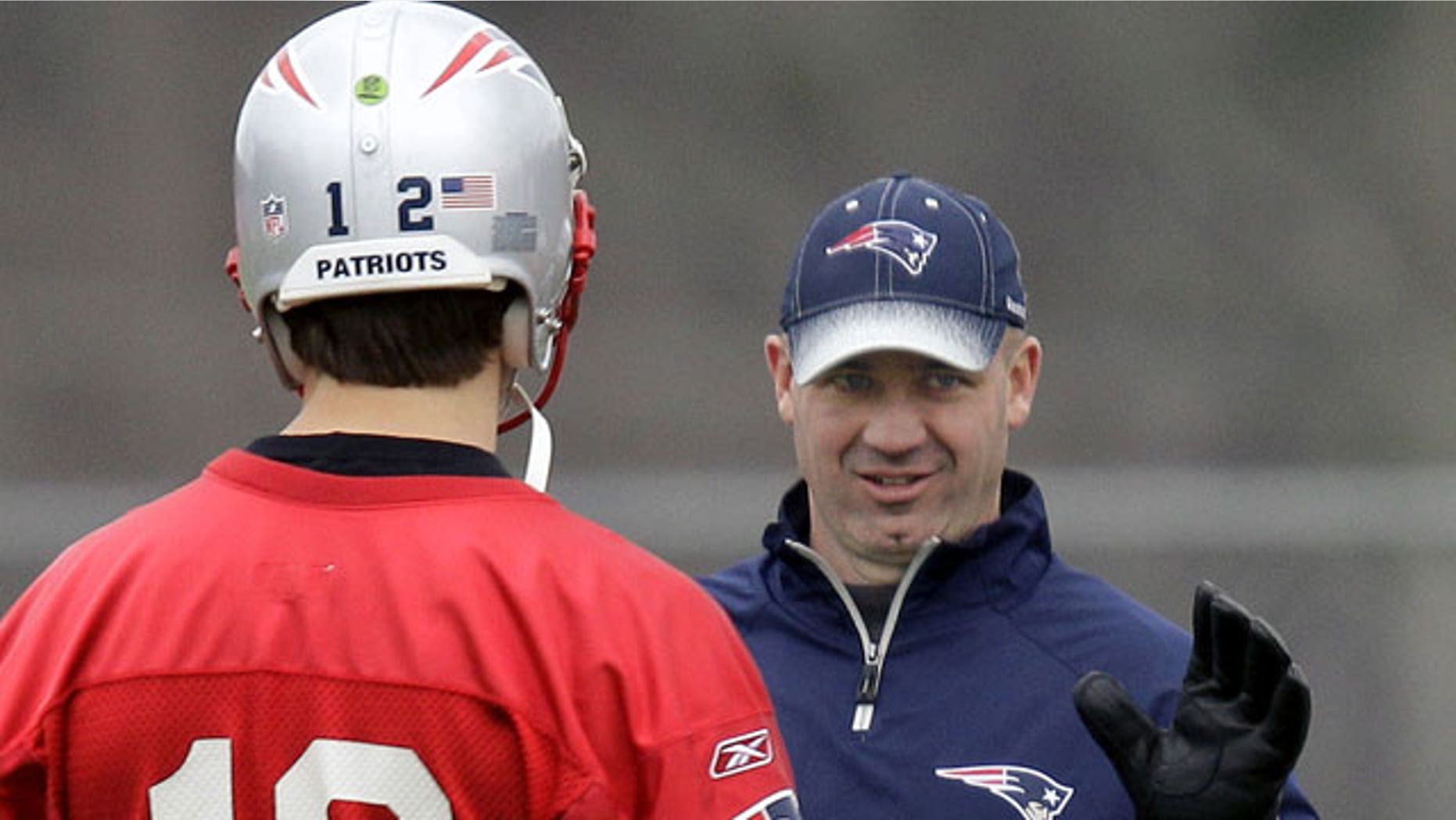 In this Dec. 14, 2011, file photo, New England Patriots offensive coordinator/quarterbacks coach Bill O'Brien talks with quarterback Tom Brady (12) during NFL football practice in Foxborough, Mass.