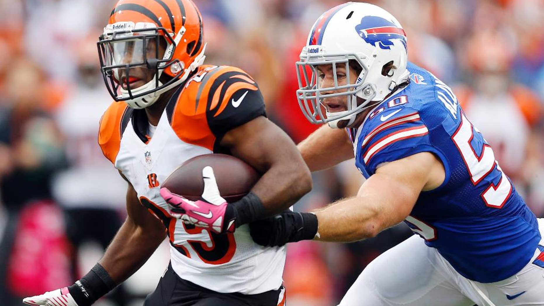 FILE - In this Oct. 13, 2013, file photo, Cincinnati Bengals' Giovani Bernard (25) runs downfield as Buffalo Bills' Kiko Alonso closes in during the second half of an NFL football game in Orchard Park, N.Y. General manager Doug Whaley announced that Alonso had been hurt with what the team fears to be a serious knee injury while working out in Oregon released in a statement by the team Tuesday, July 1, 2014. (AP Photo/Gary Wiepert File)
