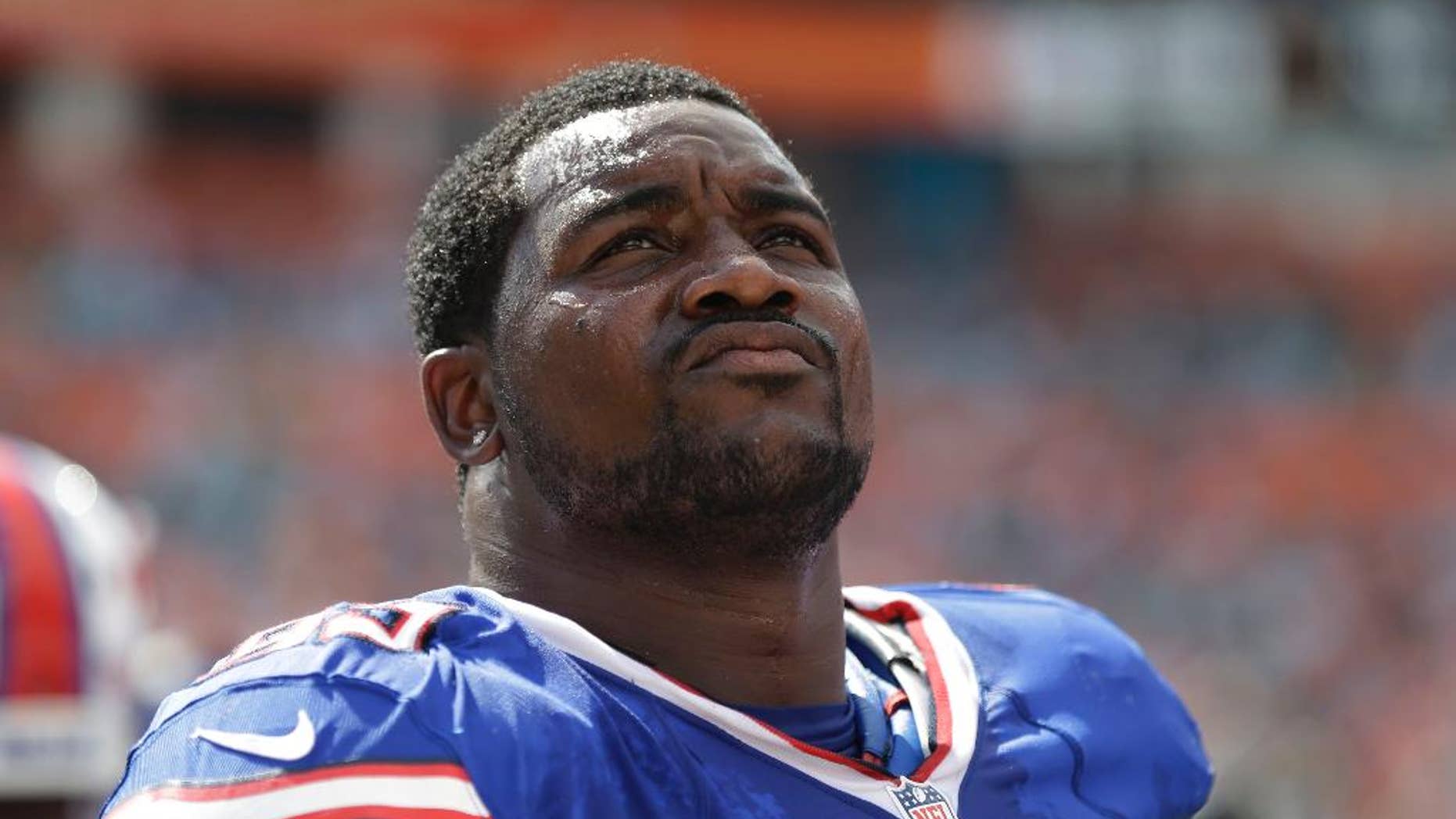FILe - This Oct. 20, 2013 file photo shows Buffalo Bills defensive tackle Marcell Dareus (99) looking up during the first half of an NFL football game against the Miami Dolphins in Miami Gardens, Fla. Dareus will miss the next two weeks of voluntary practices to take time off from football in a bid to get his life and career on track following his latest off-field legal issue. Coach Doug Marrone made the announcement after practice Tuesday, June 3, 2014, four days after Dareus crashed his Jaguar into a tree while allegedly racing another car not far from the Bills' stadium. (AP Photo/Lynne Sladky, File)