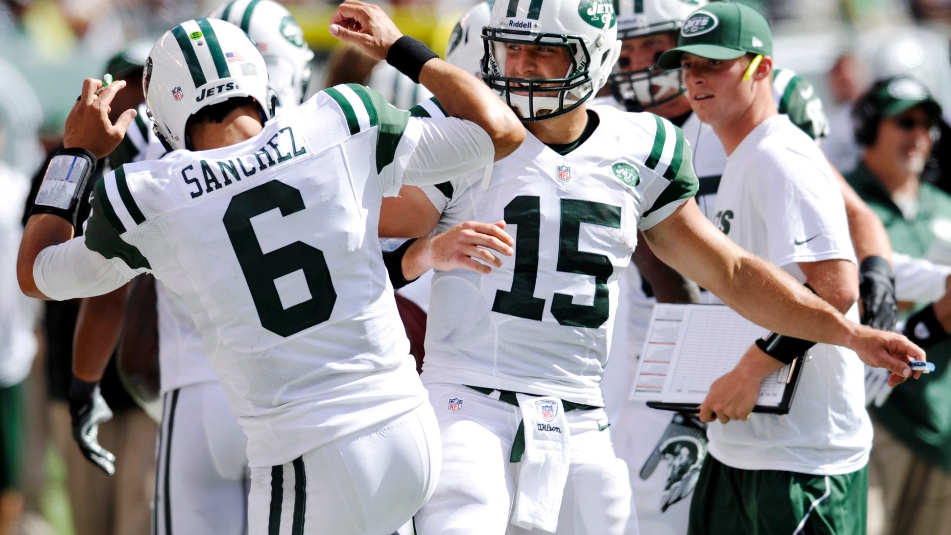New York Jets quarterbacks Mark Sanchez, left, and Tim Tebow celebrate after a touchdown during the second half of an NFL football game against the Buffalo Bills at MetLife Stadium, Sunday, Sept. 9, 2012, in East Rutherford, N.J. (AP Photo/Bill Kostroun)