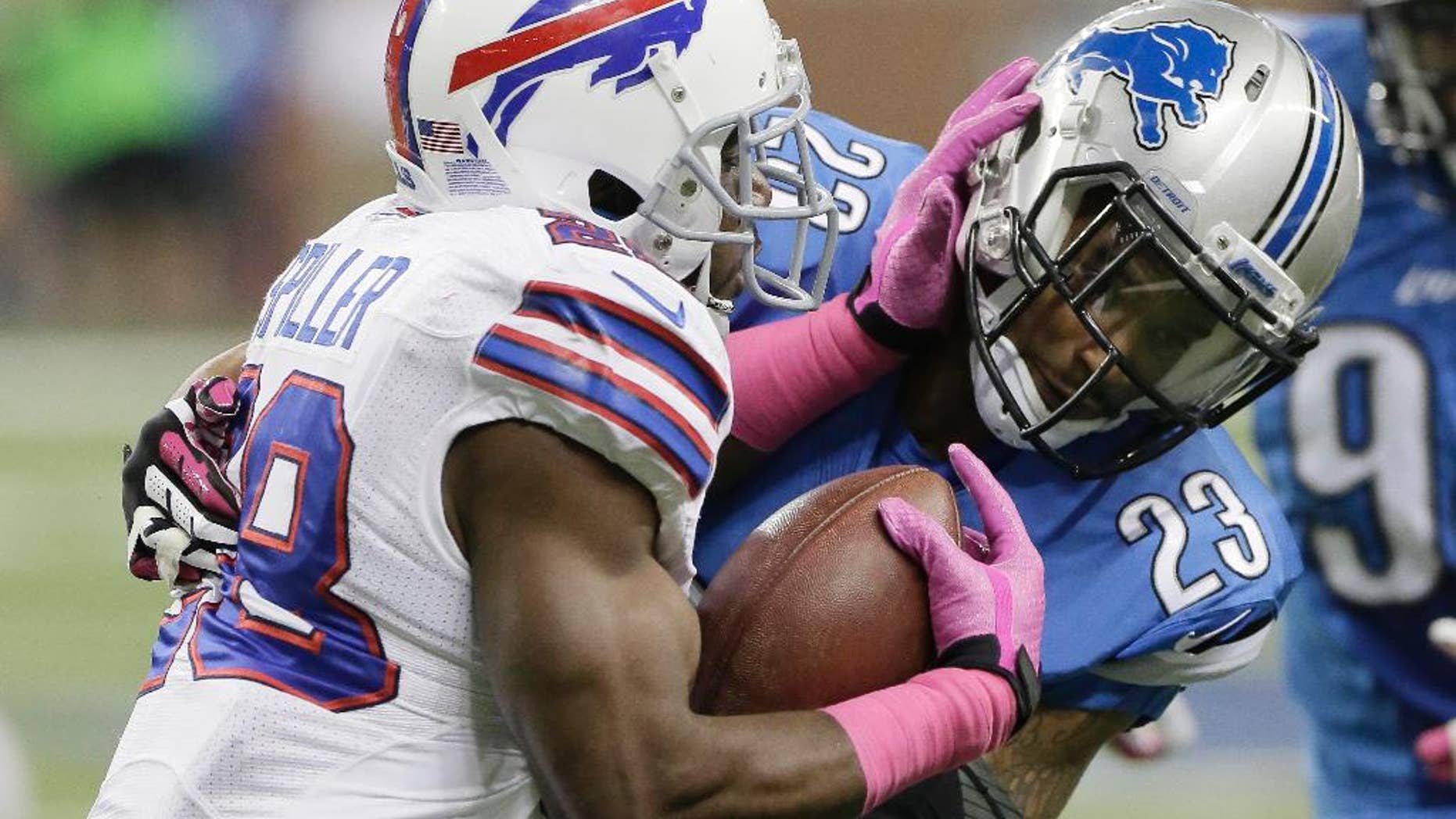 FILE - In this Oct. 5, 2014, file photo, Buffalo Bills running back C.J. Spiller (28) is stopped by Detroit Lions cornerback Darius Slay during the first quarter of an NFL football game in Detroit. Spiller is suddenly becoming the forgotten player in the Buffalo Bills backfield. The former first-round draft pick's production and playing time have plunged over the past two games. (AP Photo/Duane Burleson, File)